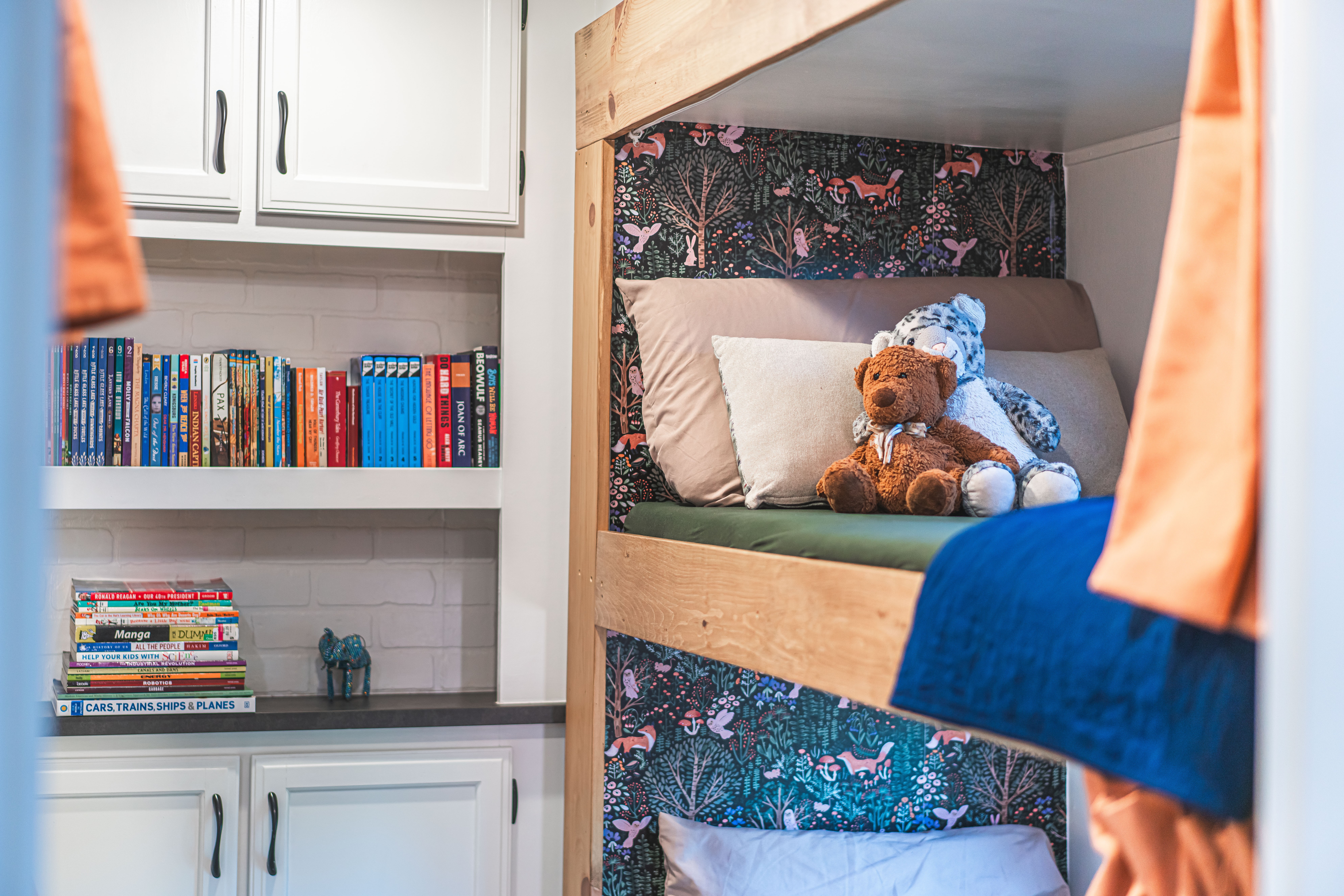 A bookshelf and bunkbeds inside Renee Tilby's Jayco Jay Flight travel trailer.