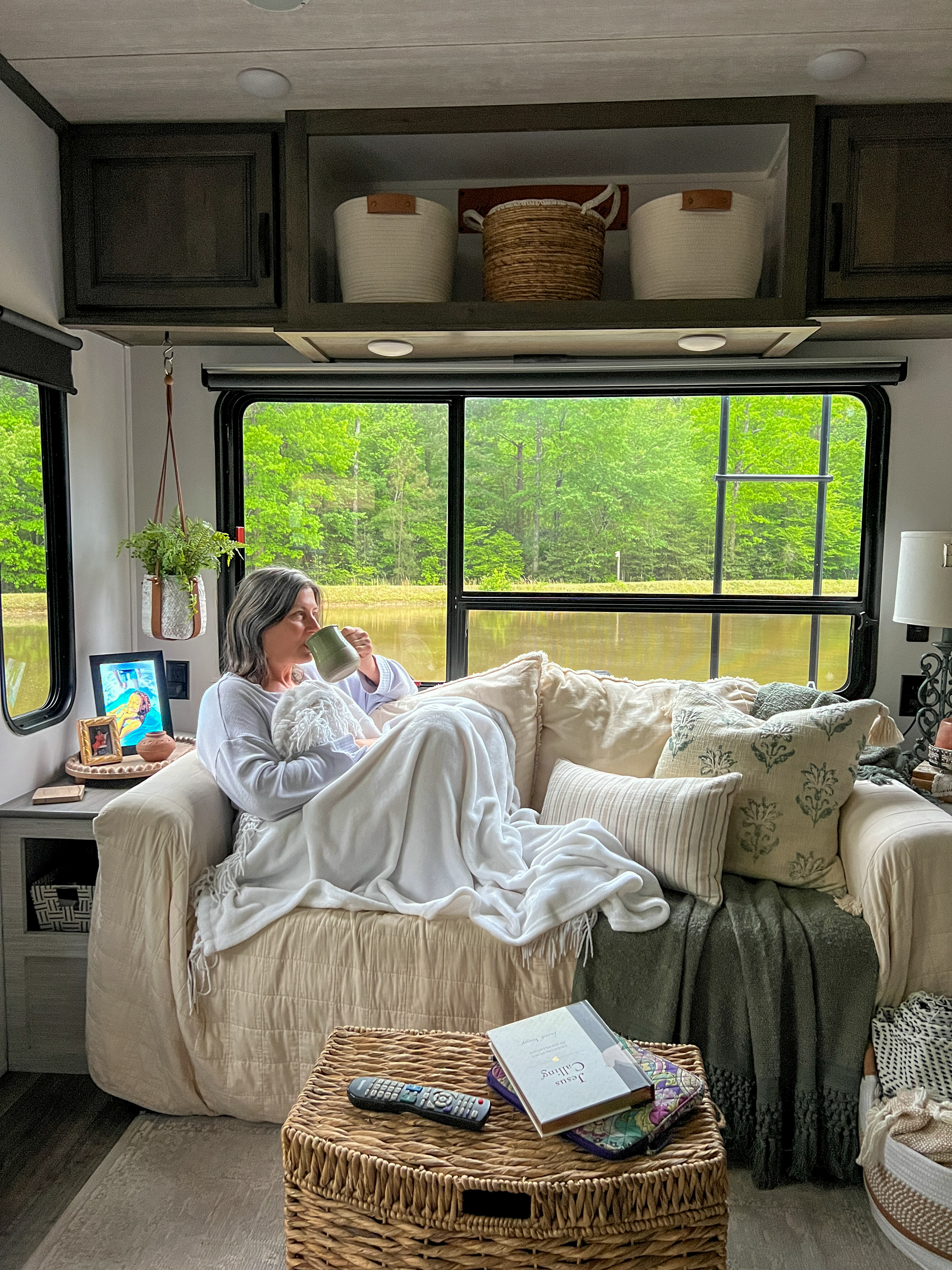 Tammy Benedict lounges on the couch in her Keystone Cougar travel trailer.