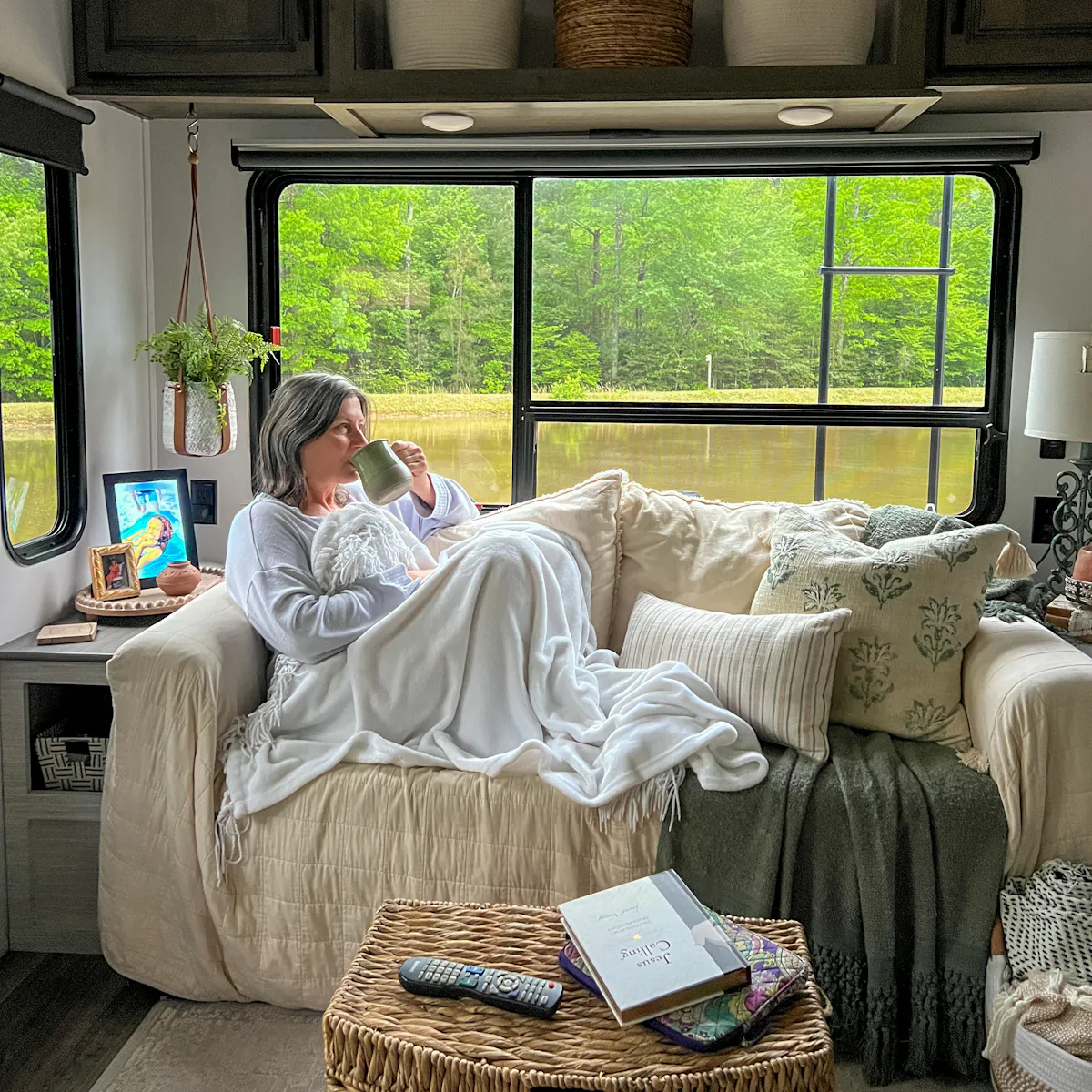 Tammy Benedict lounges on the couch in her Keystone Cougar travel trailer.