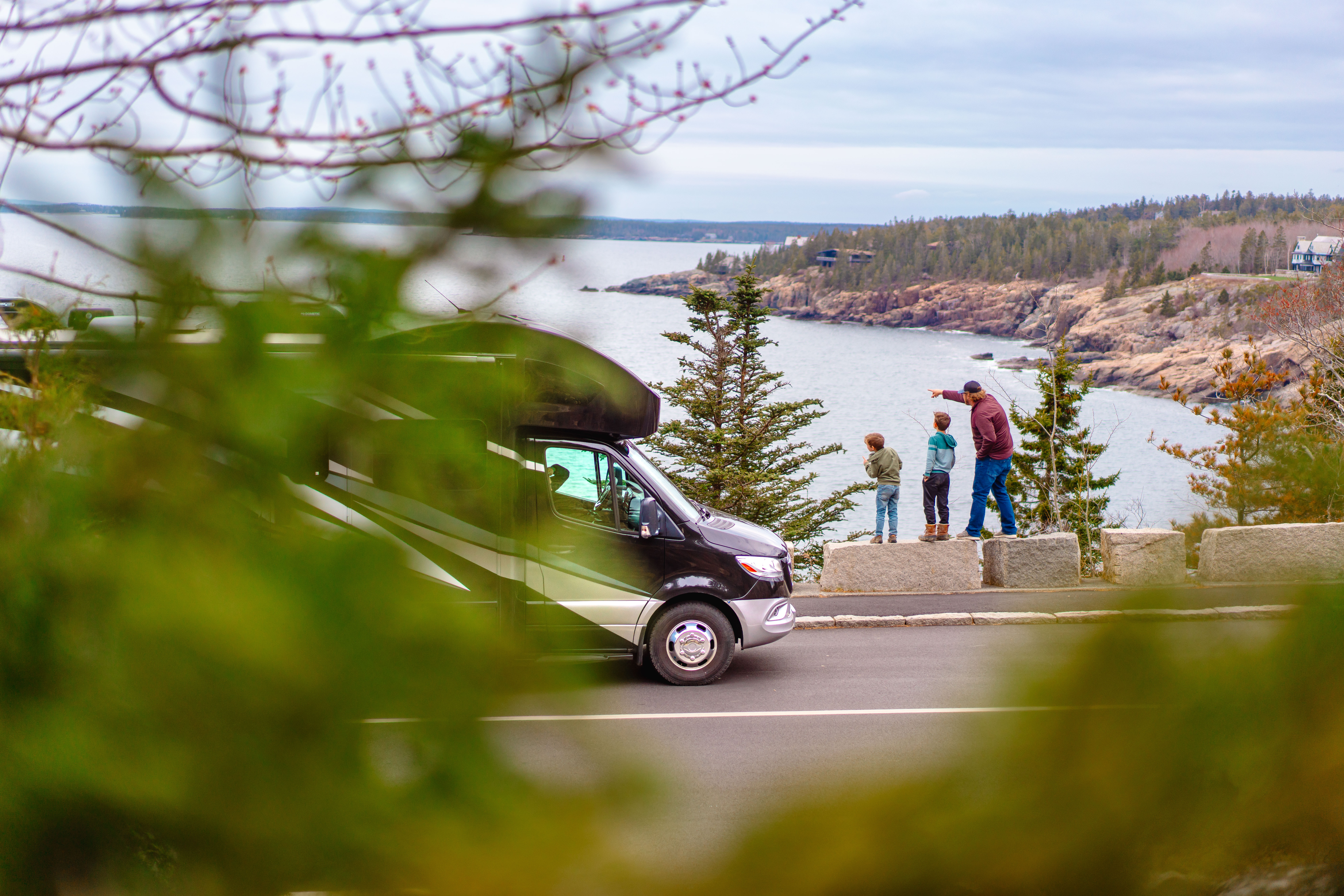 A motorized RV at a scenic outlook in Mount Desert Island, Maine with the Tilby family.