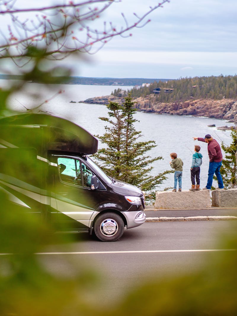 A motorized RV at a scenic outlook in Mount Desert Island, Maine with the Tilby family.