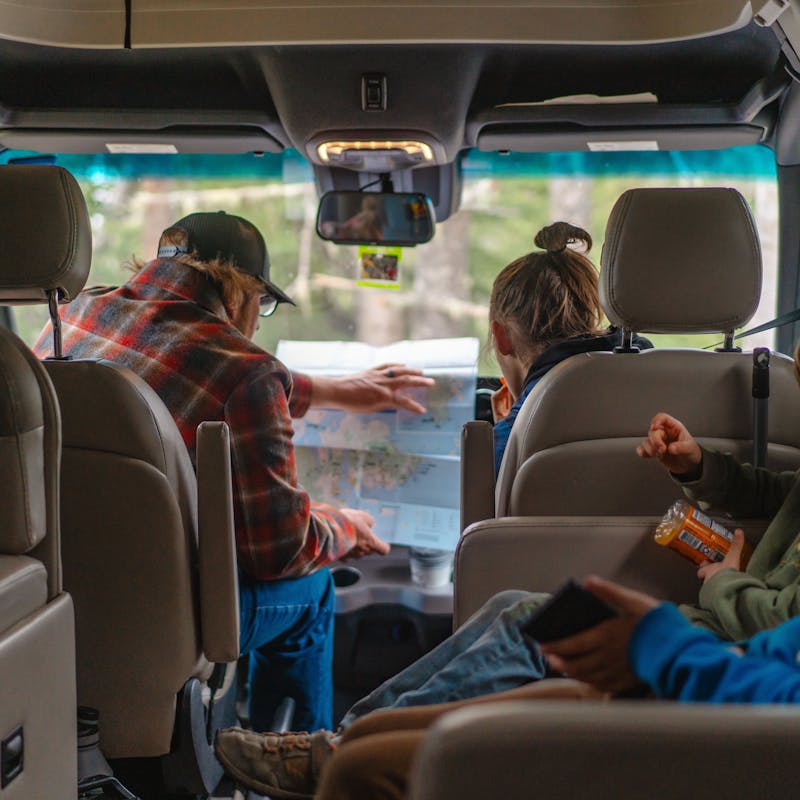 The Tilby family looks at a map while traveling in a rented motorized RV.