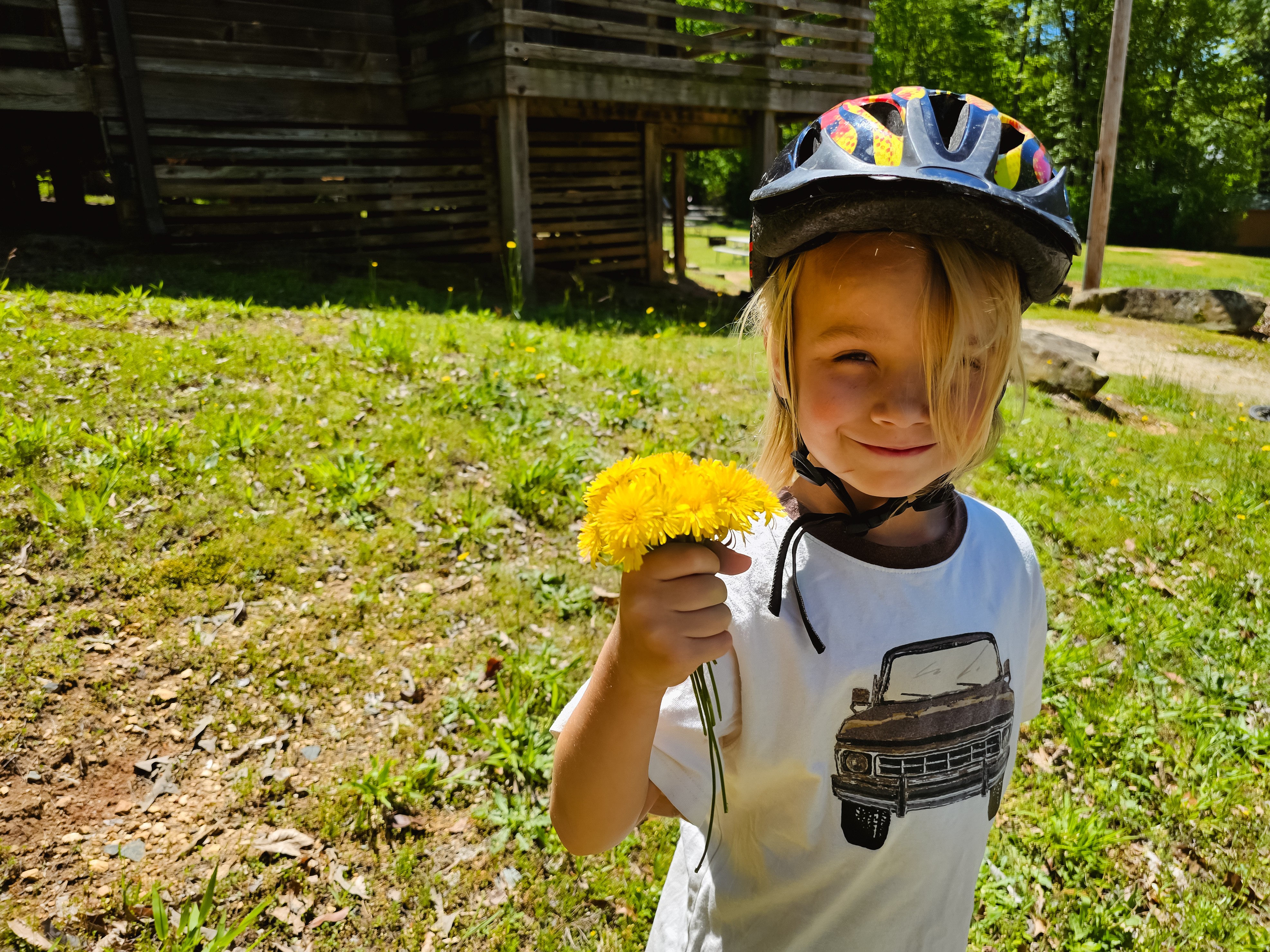 One of the Barringer's kids holds dandelion flowers.