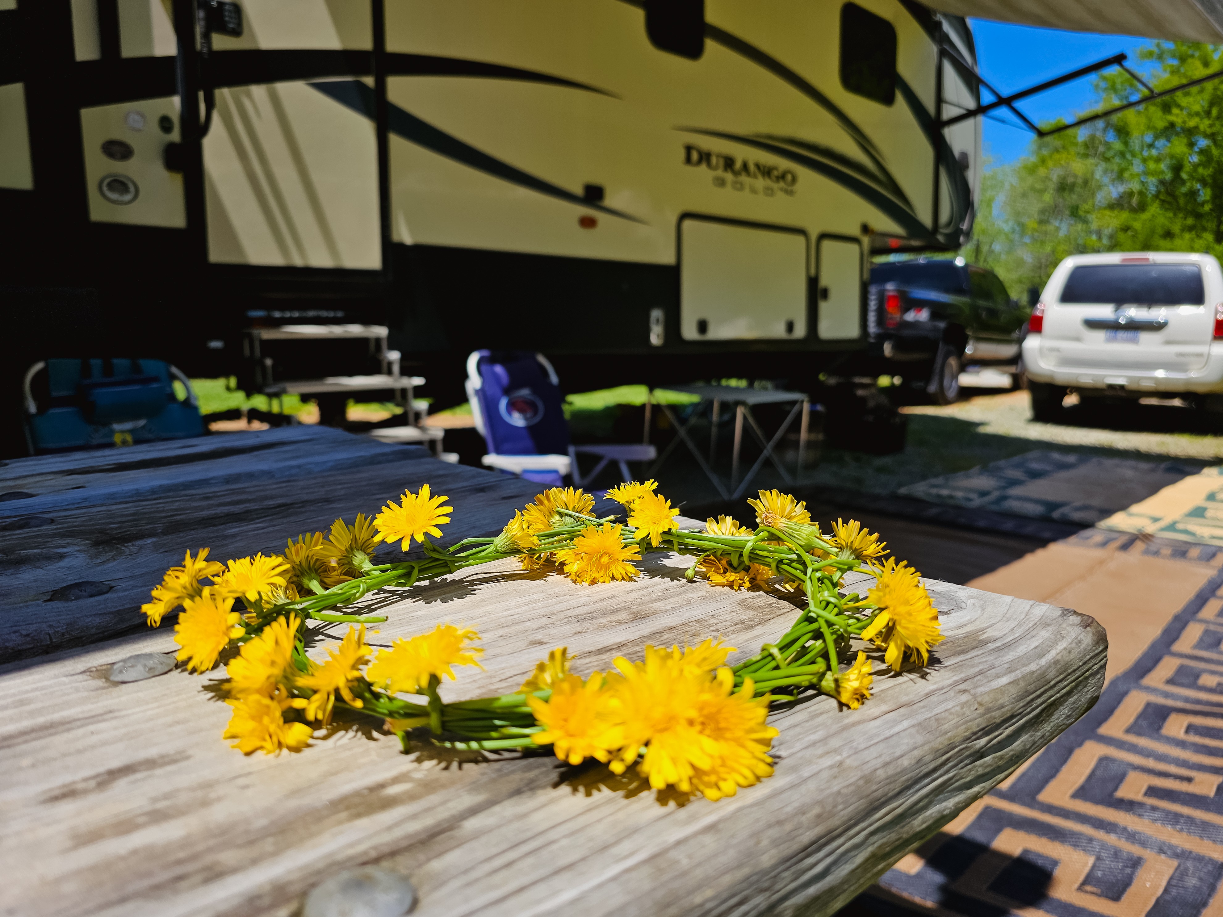 A flower crown on a picnic table next to Bibi Barringer's KZ Durango Gold fifth wheel.