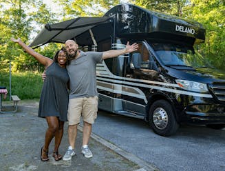 Gabe and Rocio Rivero pose in front of their Thor Motor Coach Delano Class C Motorhome.