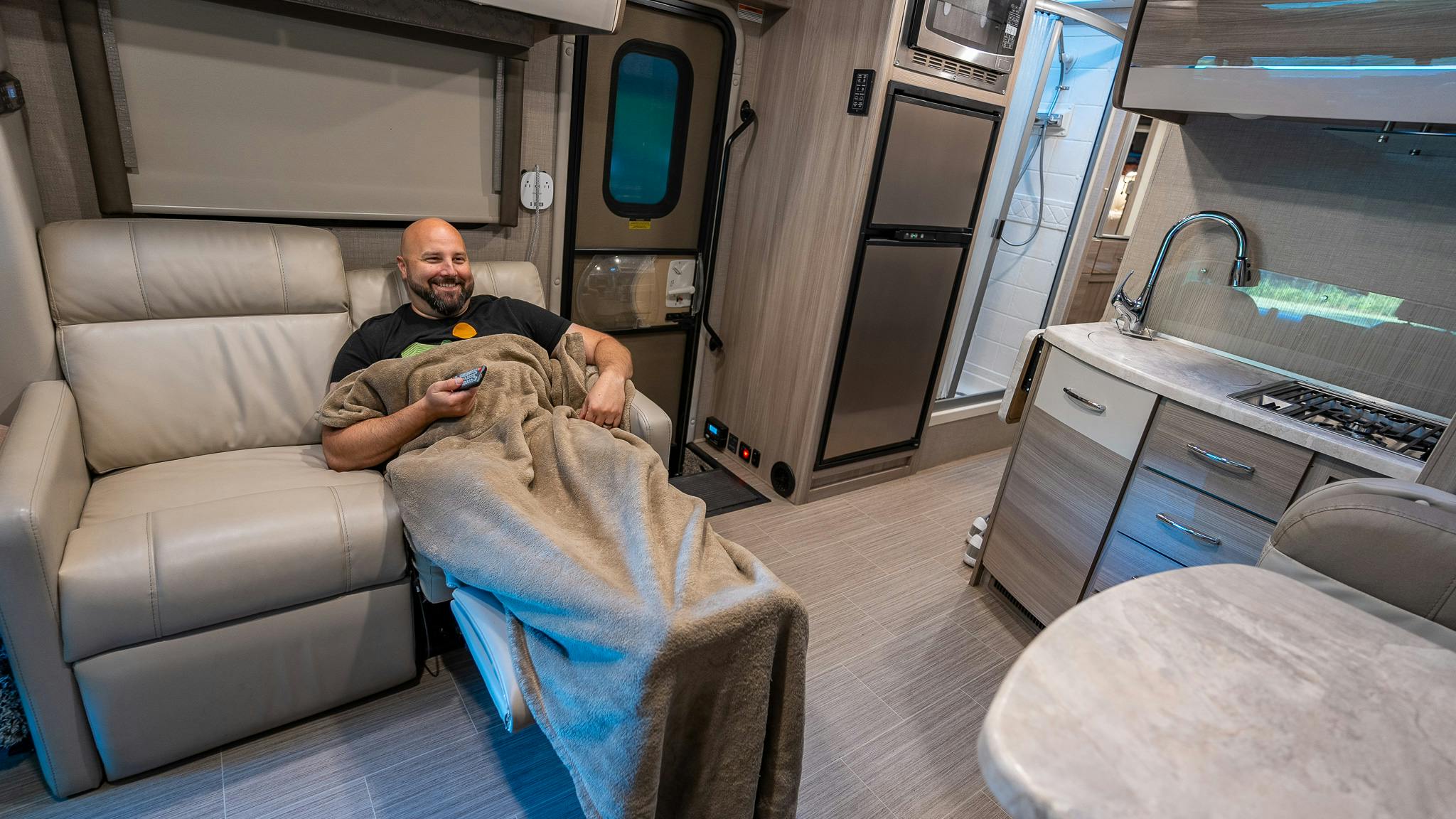 Gabe Rivero lounges on the couch inside his Thor Motor Coach Delano Class C Motorhome.