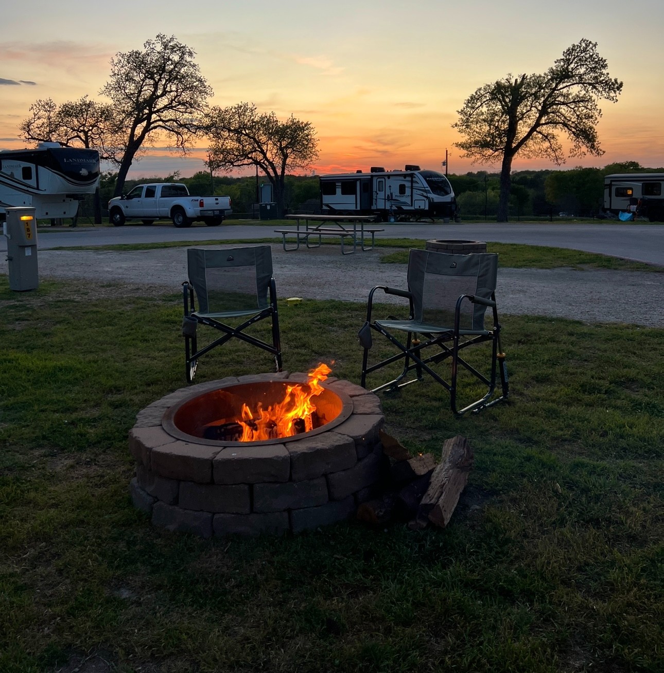 A bonfire with camp chairs at a campground, taken by Bailey and Nicole Damberg.