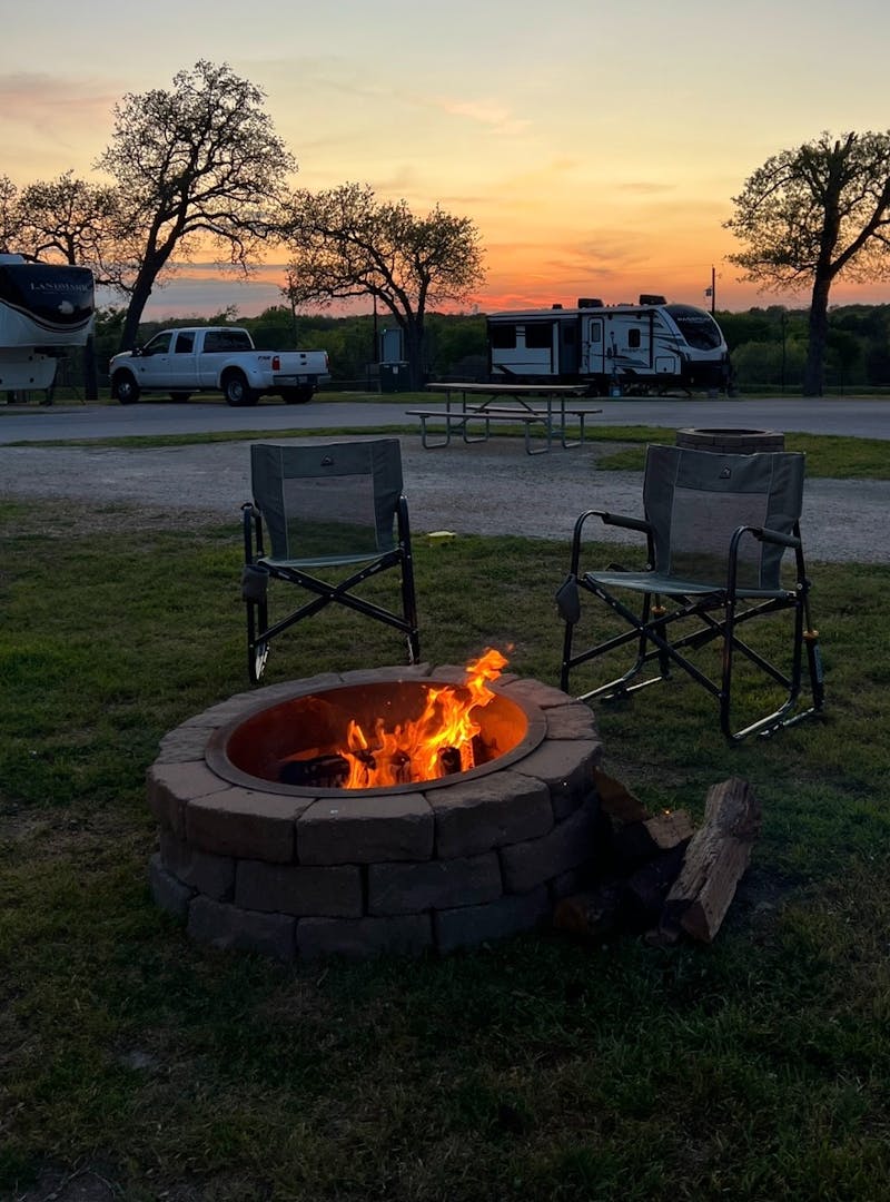 A bonfire with camp chairs at a campground, taken by Bailey and Nicole Damberg.