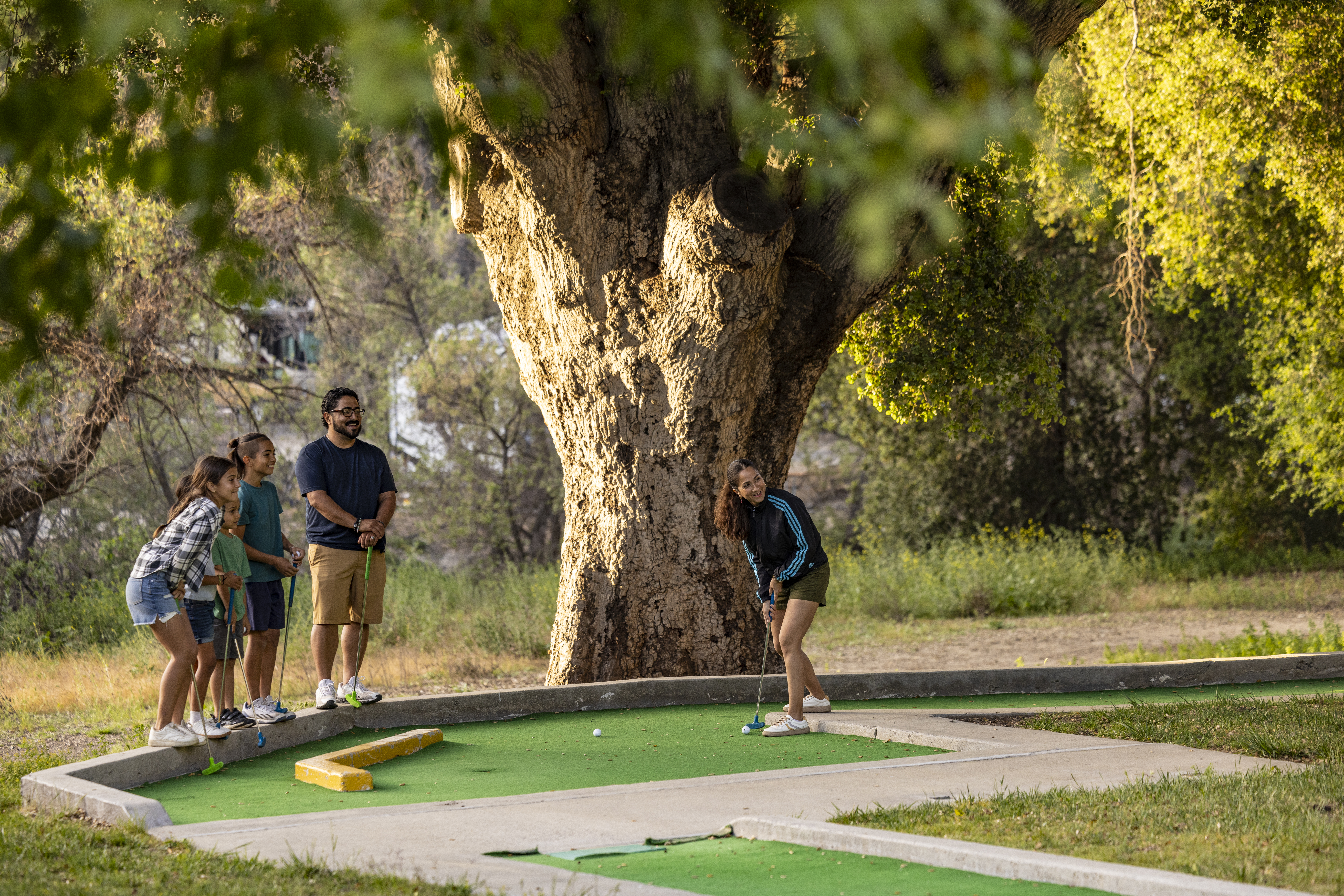 The Peña family plays miniature golf at the Temecula KOA Campground.