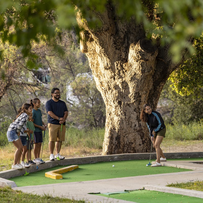 The Peña family plays miniature golf at the Temecula KOA Campground.