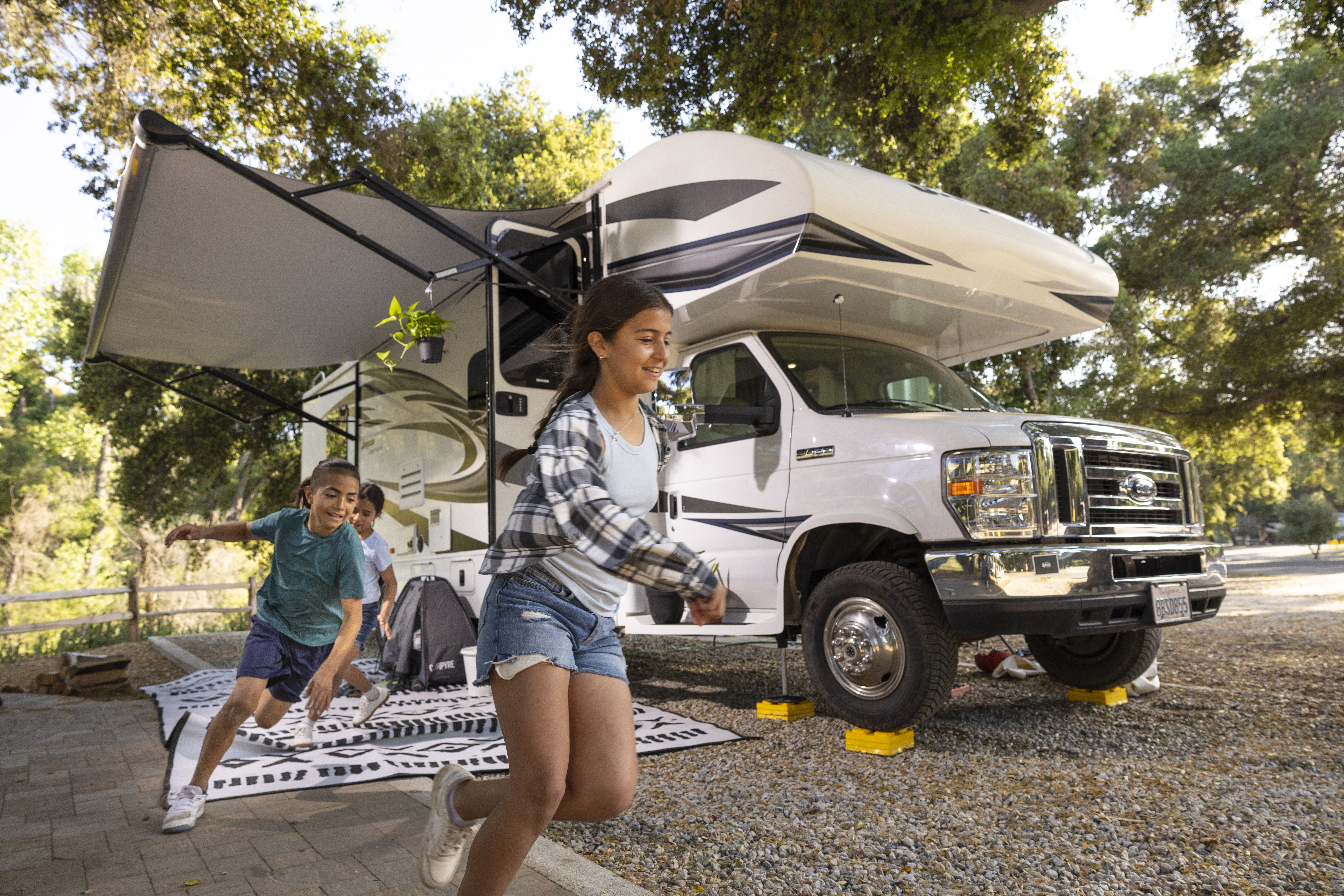 The Peña kids run out of the Jayco Greyhawk at the Temecula KOA Campground.