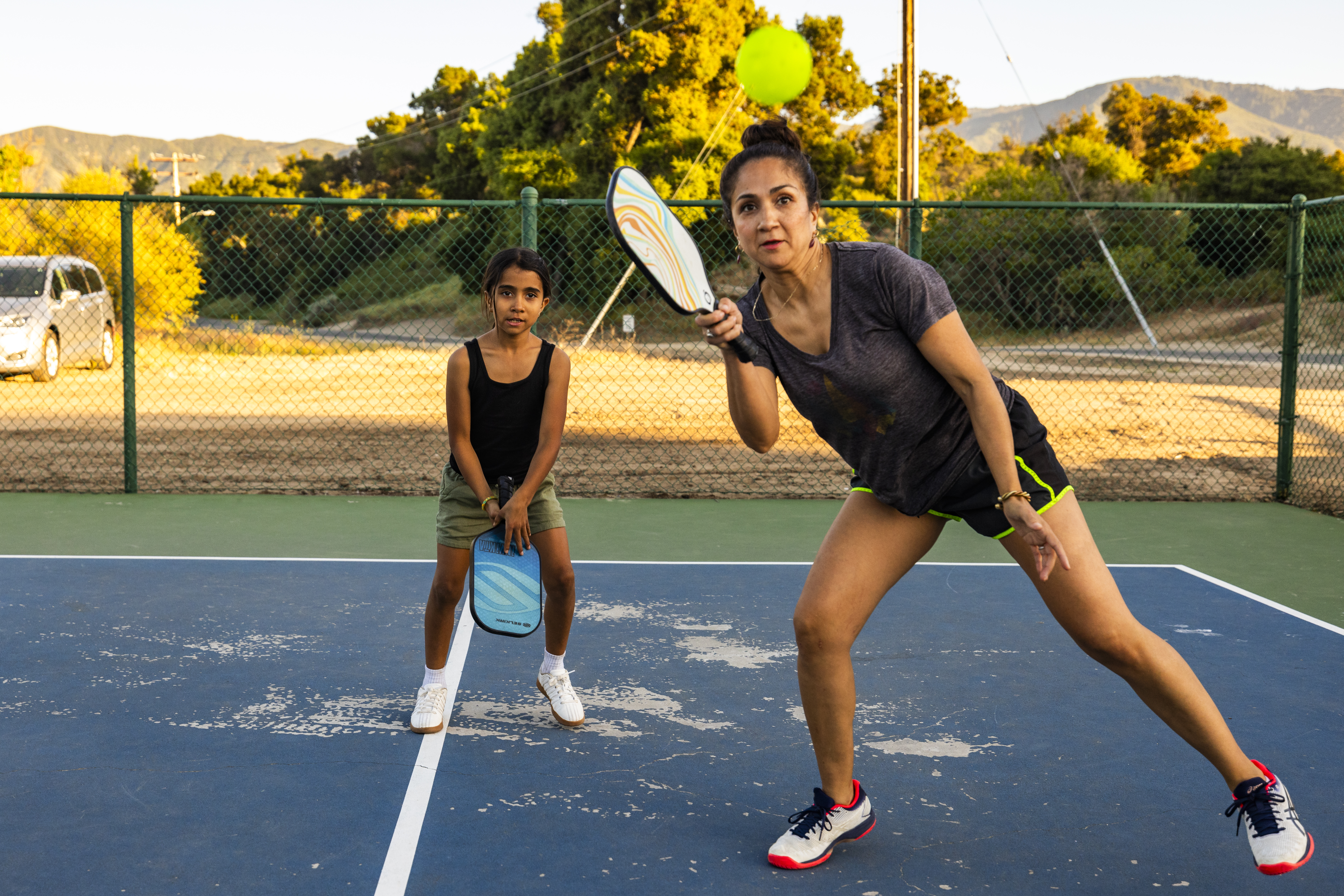 Sandra Peña and her daughter play pickleball. 