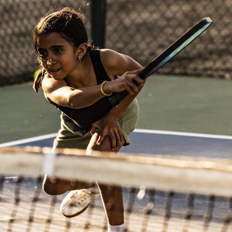 The Peña kid plays pickleball.