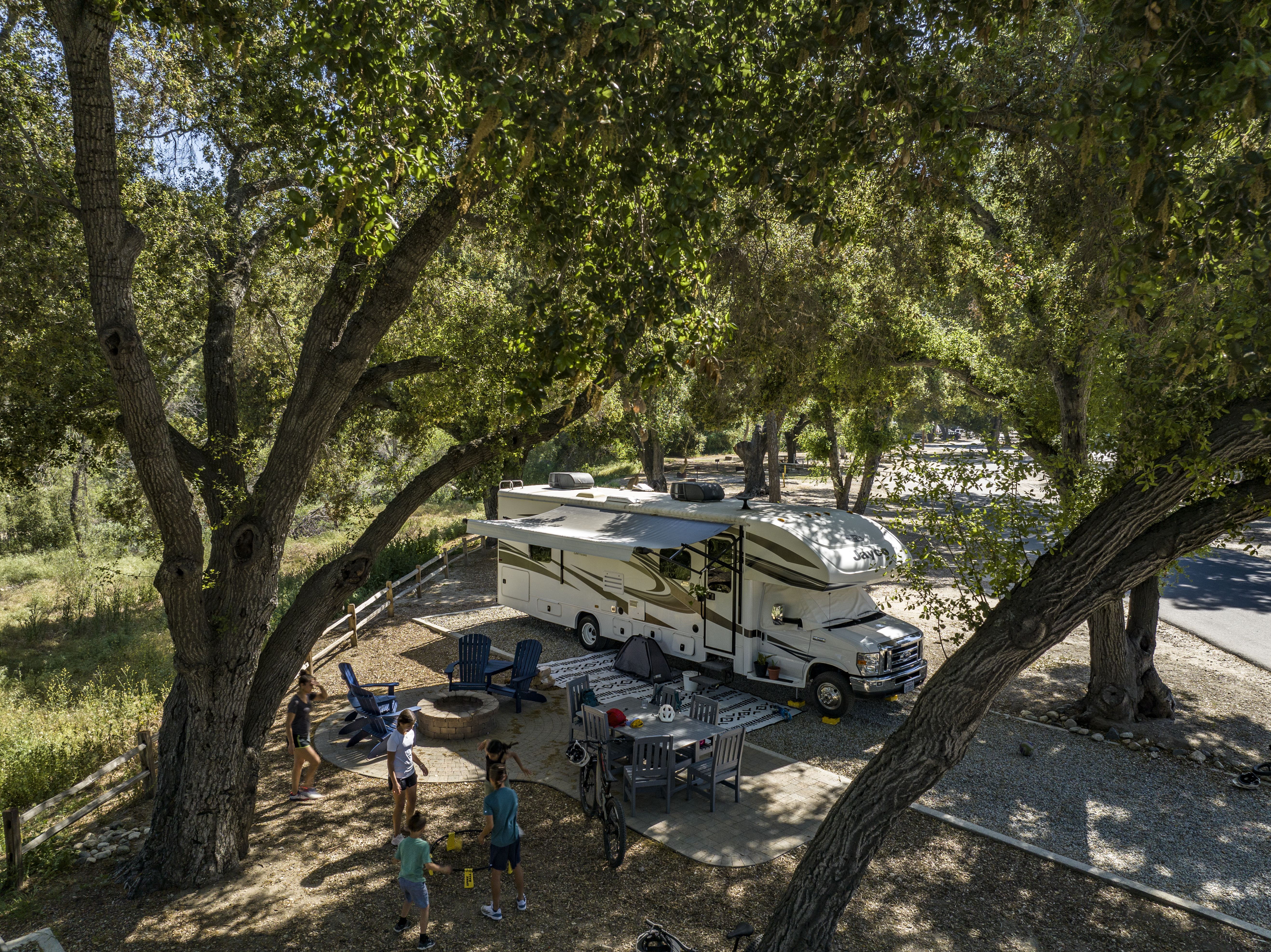 The Peña family play games at their campsite with their Jayco Greyhawk.