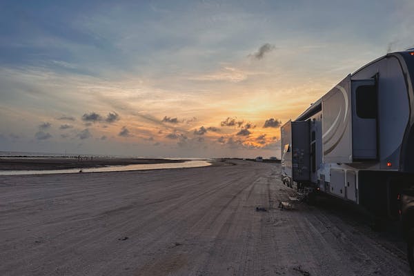 Cassie and Joshua Bailey's Highland Ridge Open Range fifth wheel parked at the beach.