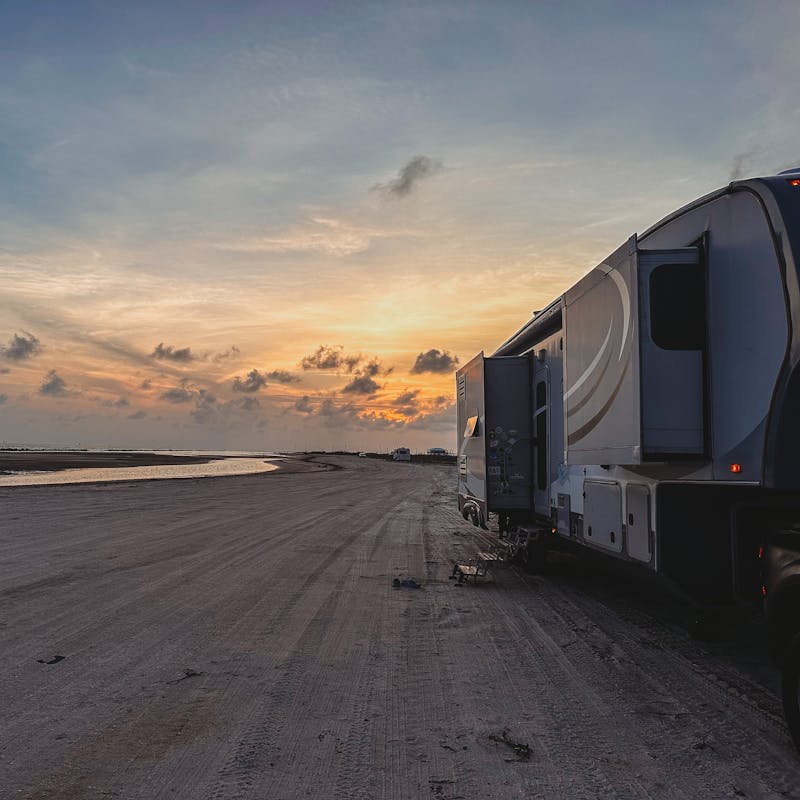 Cassie and Joshua Bailey's Highland Ridge Open Range fifth wheel parked at the beach.