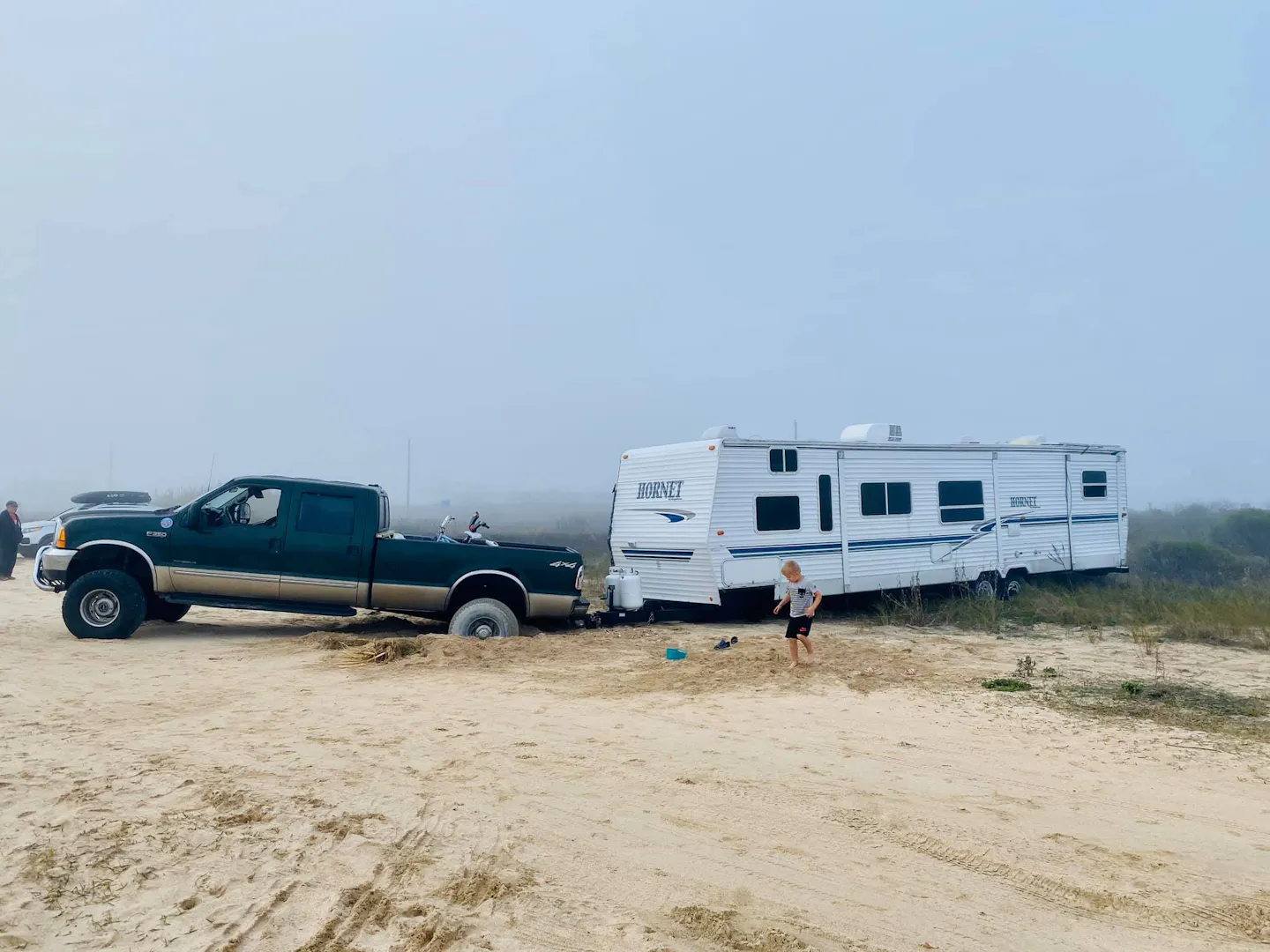 Cassie and Joshua Bailey's Highland Ridge Open Range fifth wheel stuck in the sand.