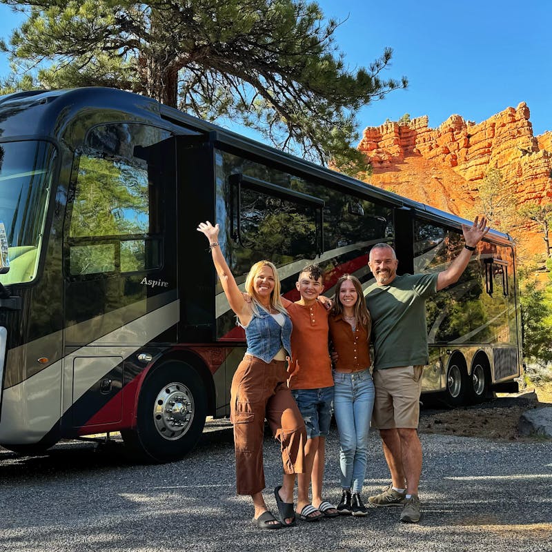 Carrie Cassity and her family pose in front of their Class A Entegra Vision motorhome.