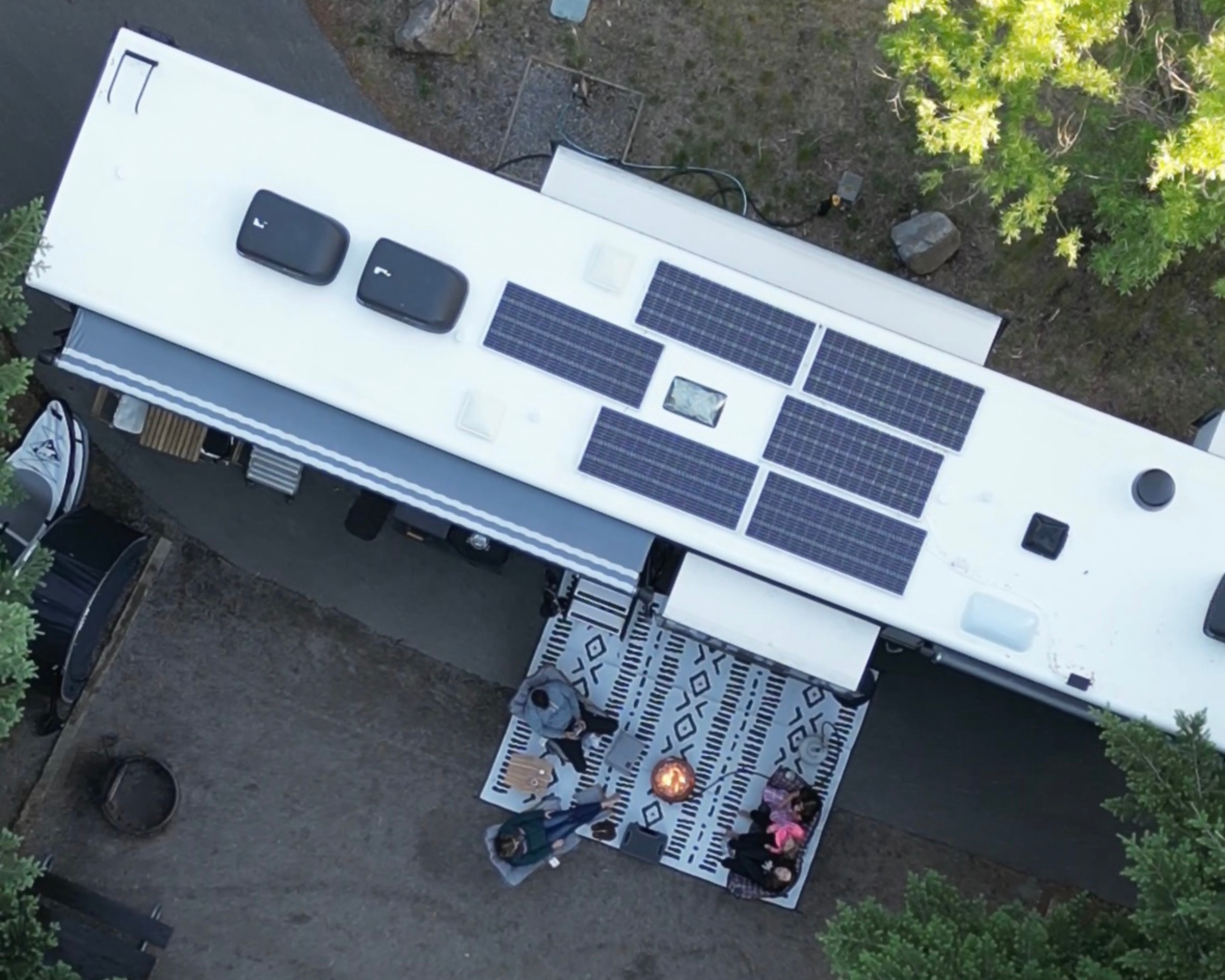 An aerial view of Ashley Peeples and her family planning their next trip around a fire.