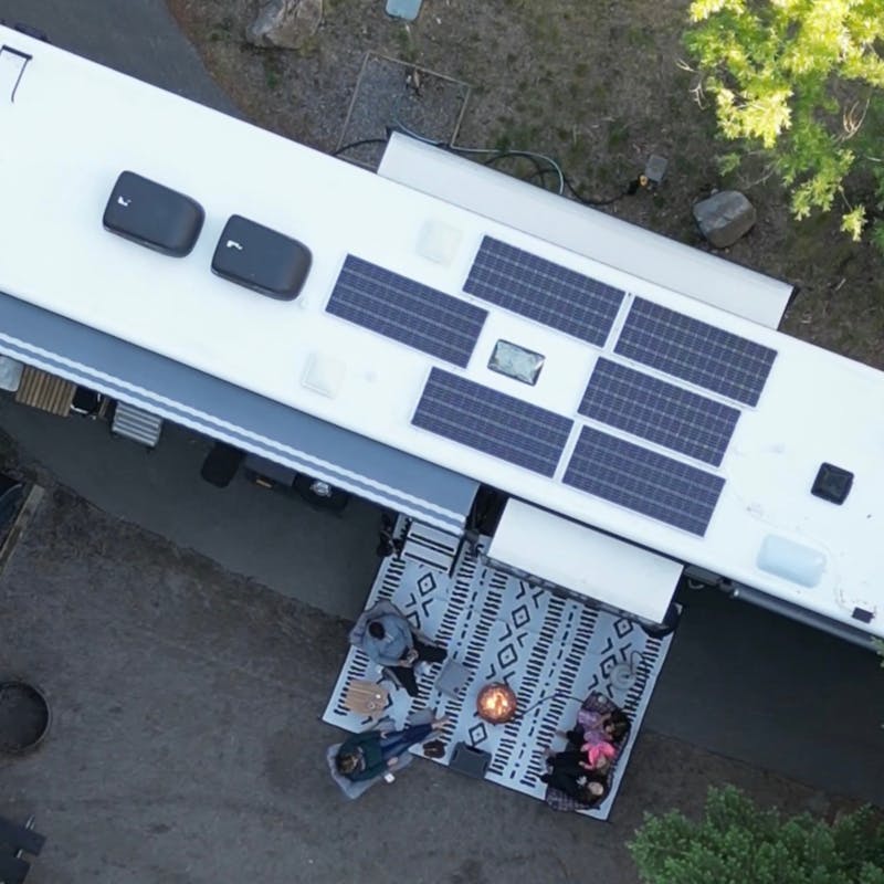 An aerial view of Ashley Peeples and her family planning their next trip around a fire.