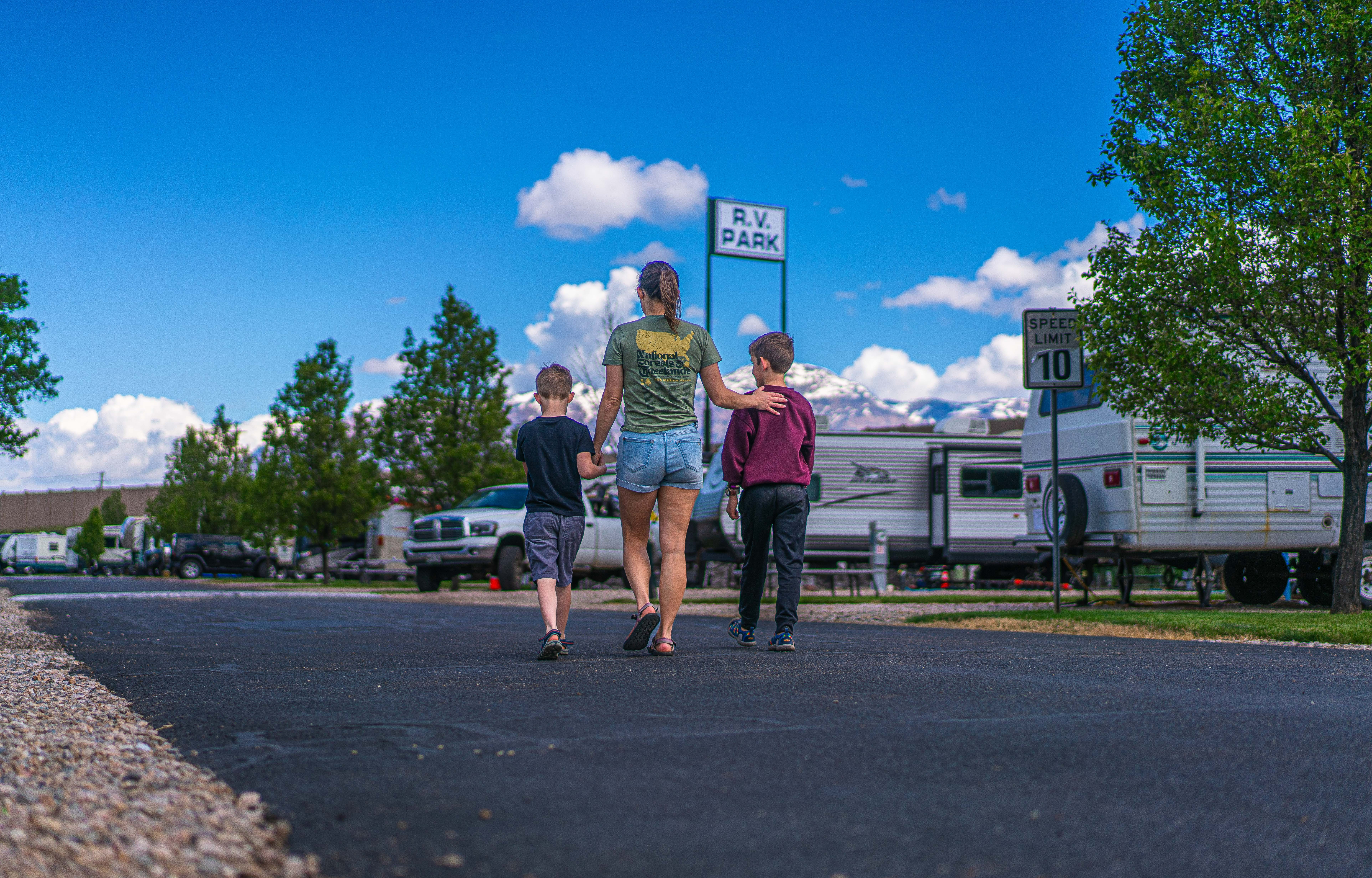 Renee Tilby walks down a road with her kids.