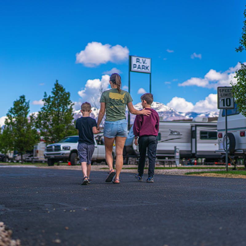 Renee Tilby walks down a road with her kids.