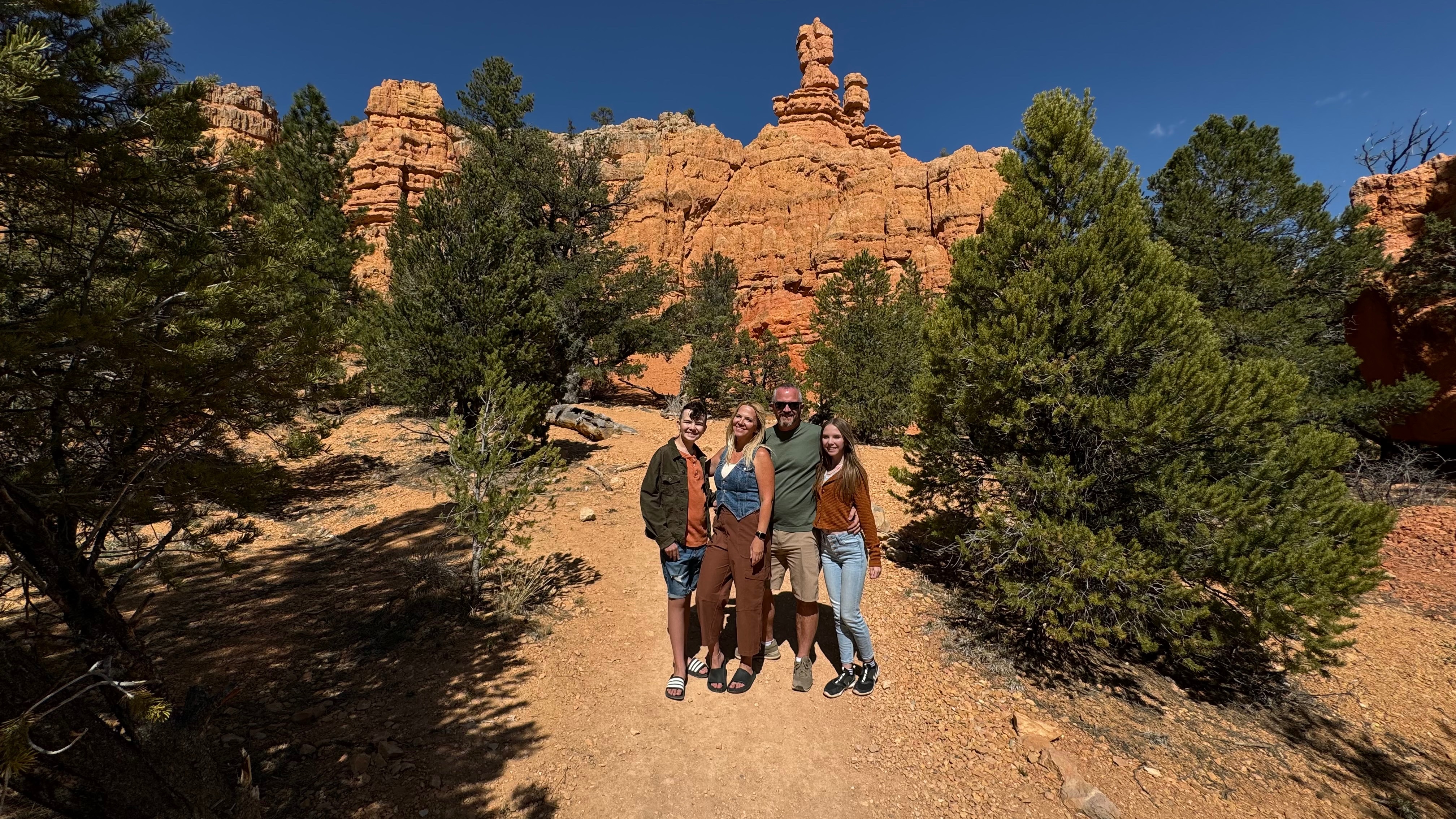 Carrie Cassity and her family pose in front of Red Canyons in Utah.