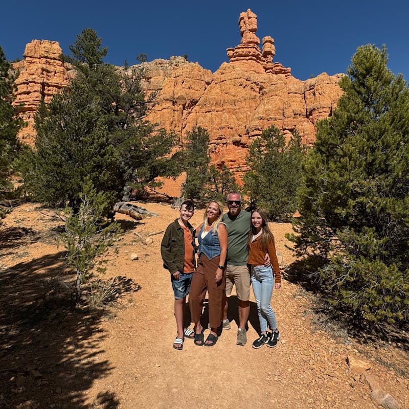Carrie Cassity and her family pose in front of Red Canyons in Utah.