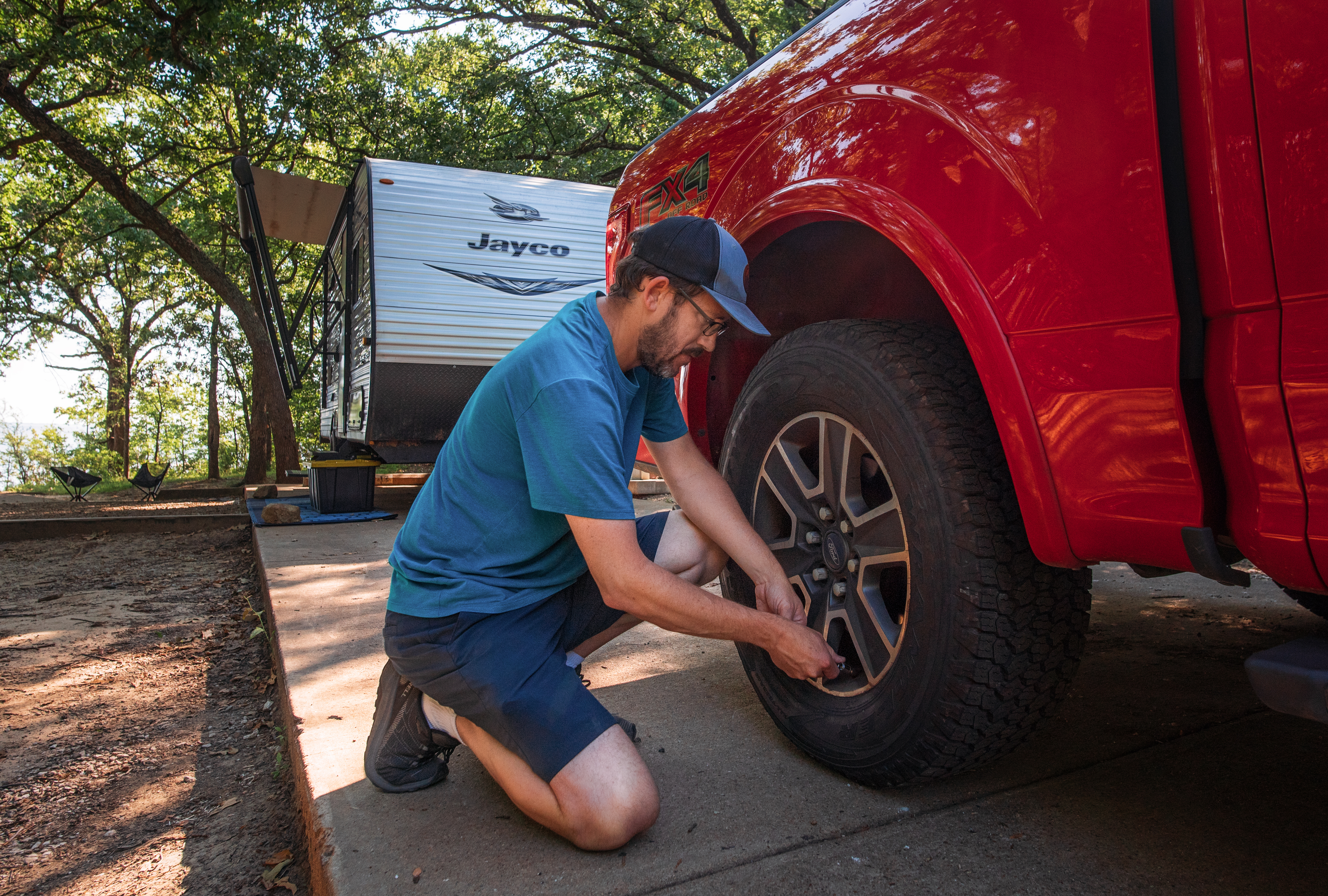 Jason Takacs checks the tire pressure on his truck.