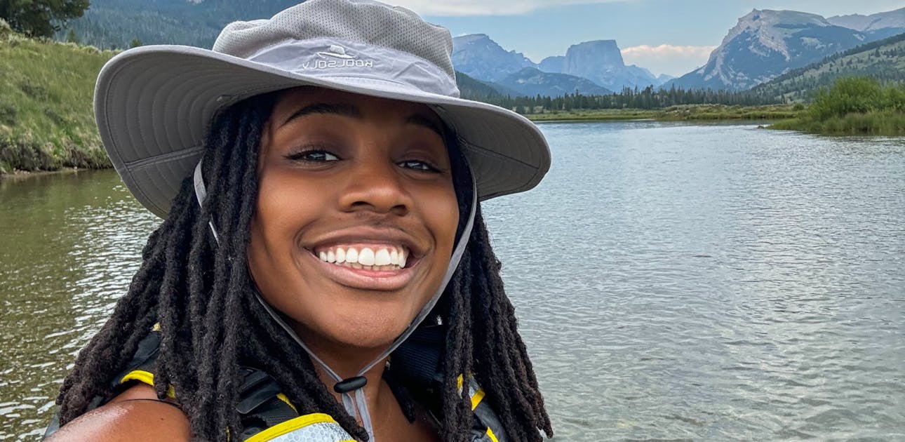 Sherise Gumbs posing in front of the Green River in Bridger-Teton National Forest.