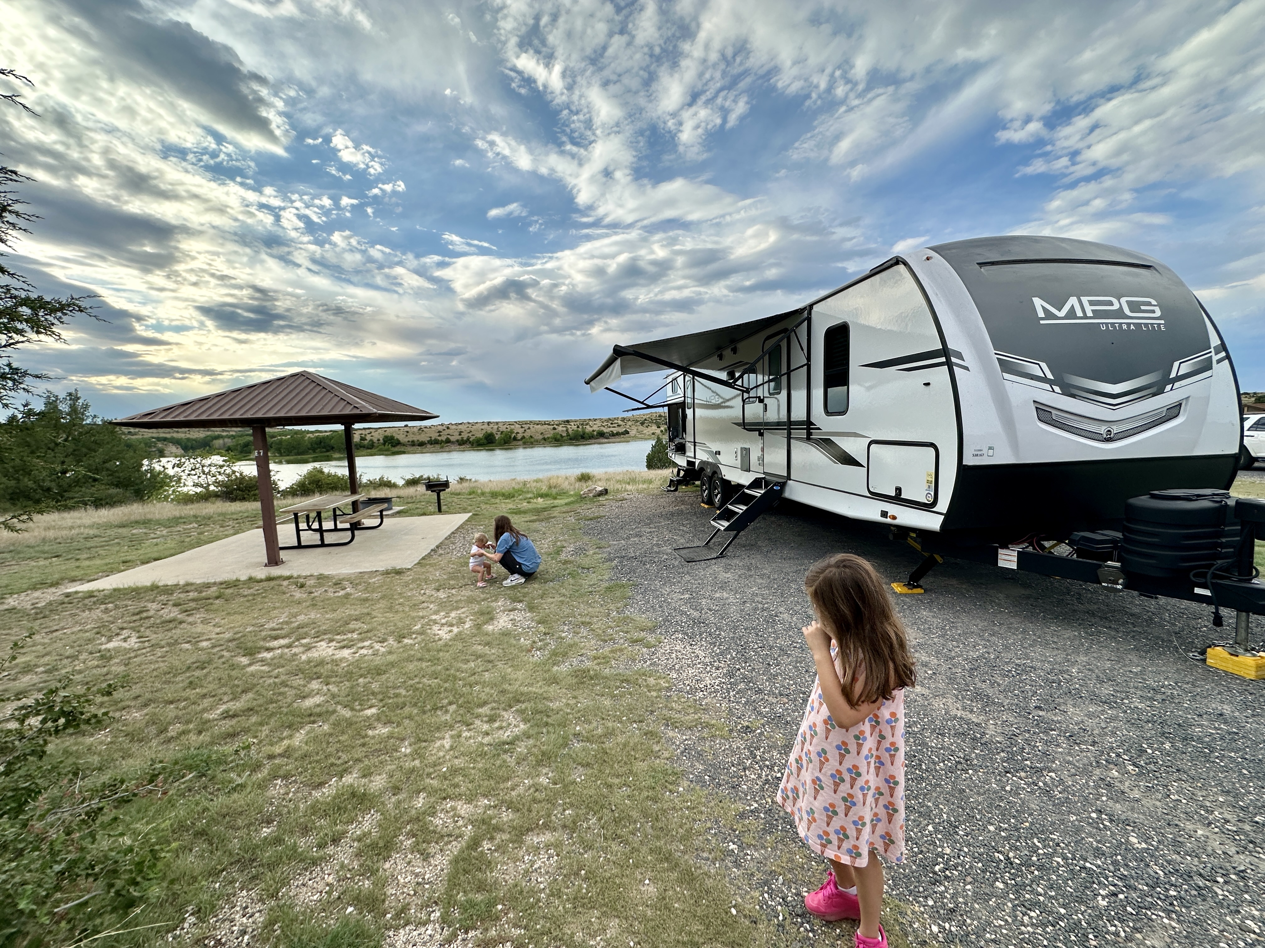 John King's family with their Cruiser MPG travel trailer parked at a campsite.