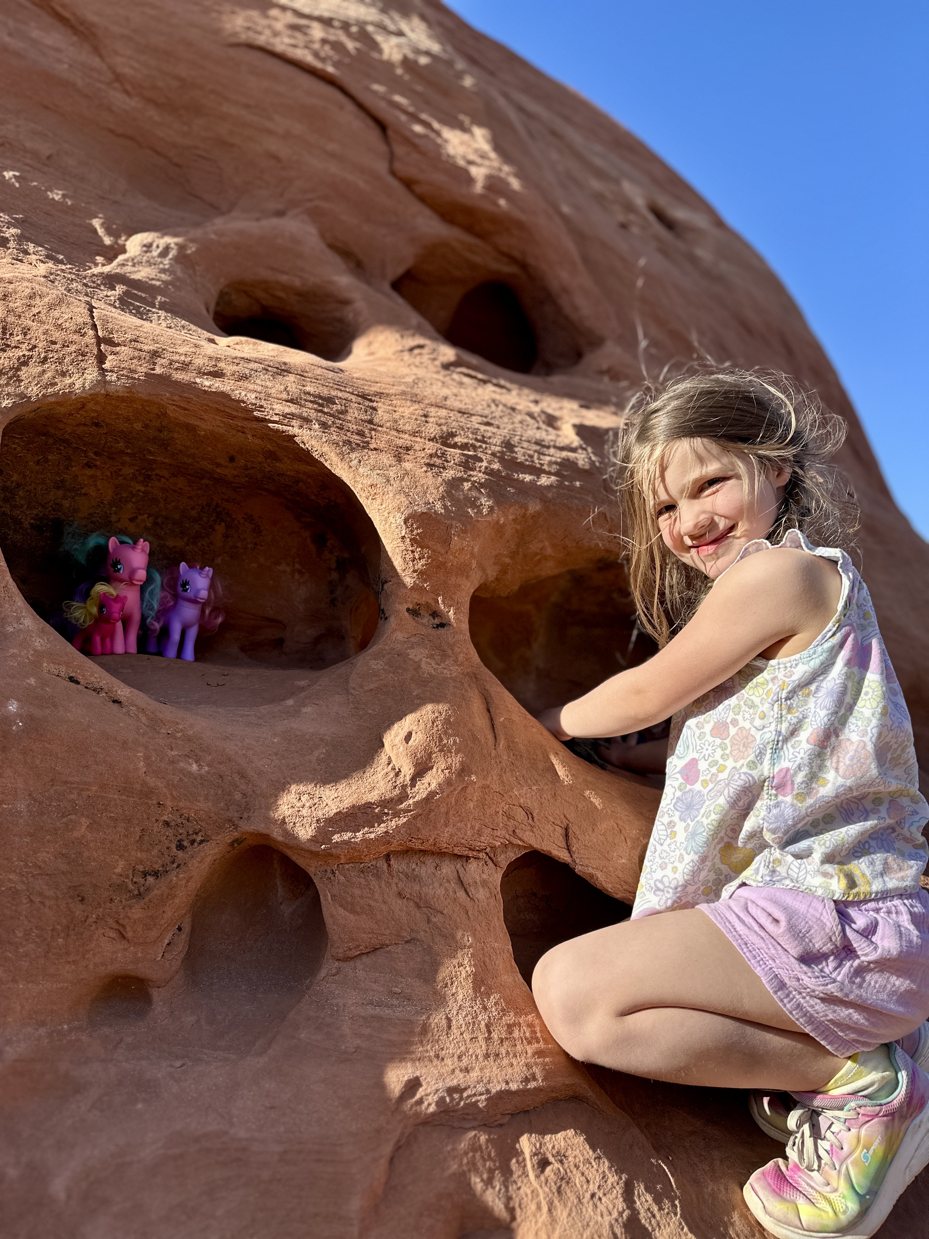 John King's daughter playing with toys and rocks.