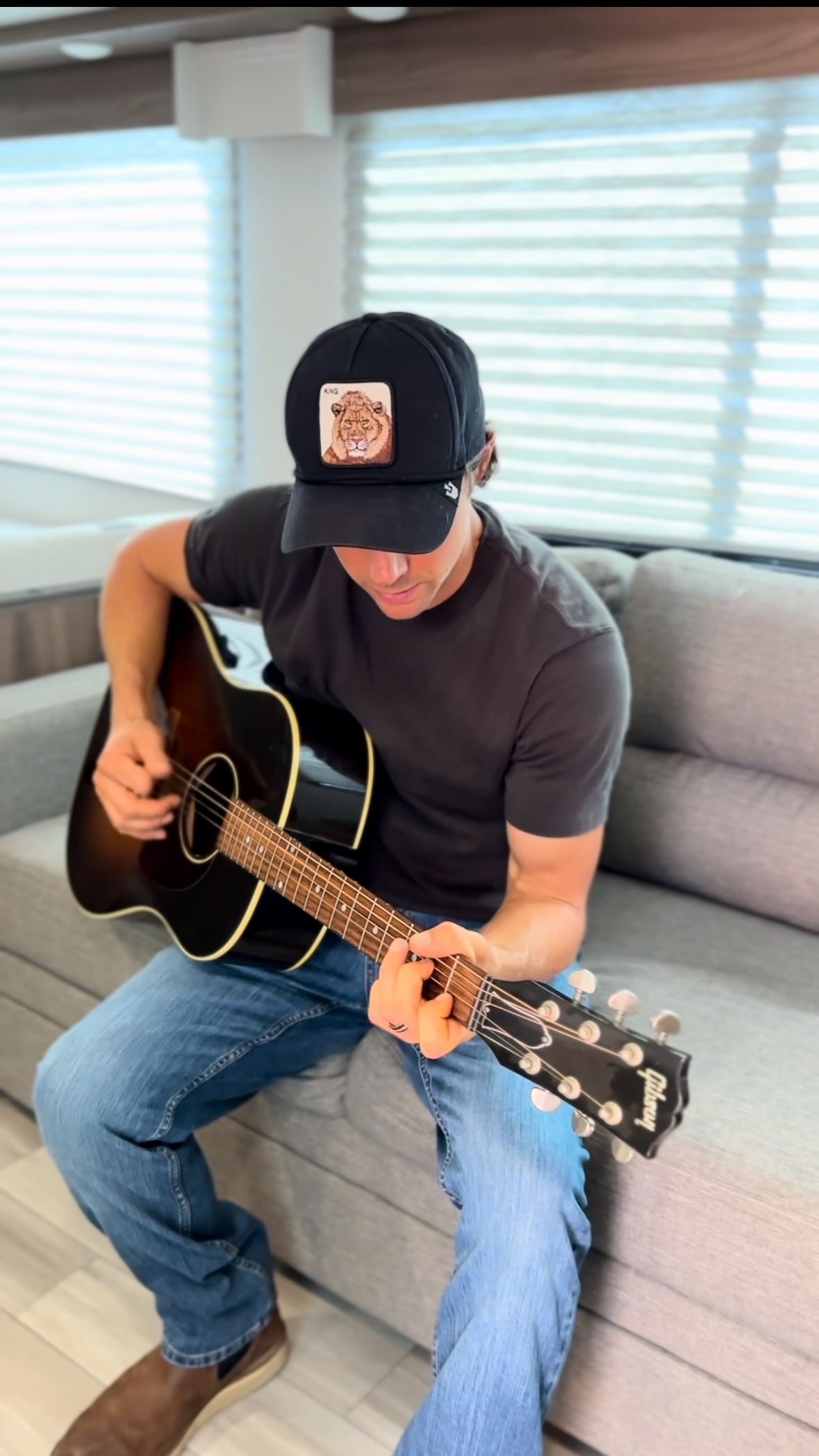 John King playing his guitar in his Cruiser MPG travel trailer.