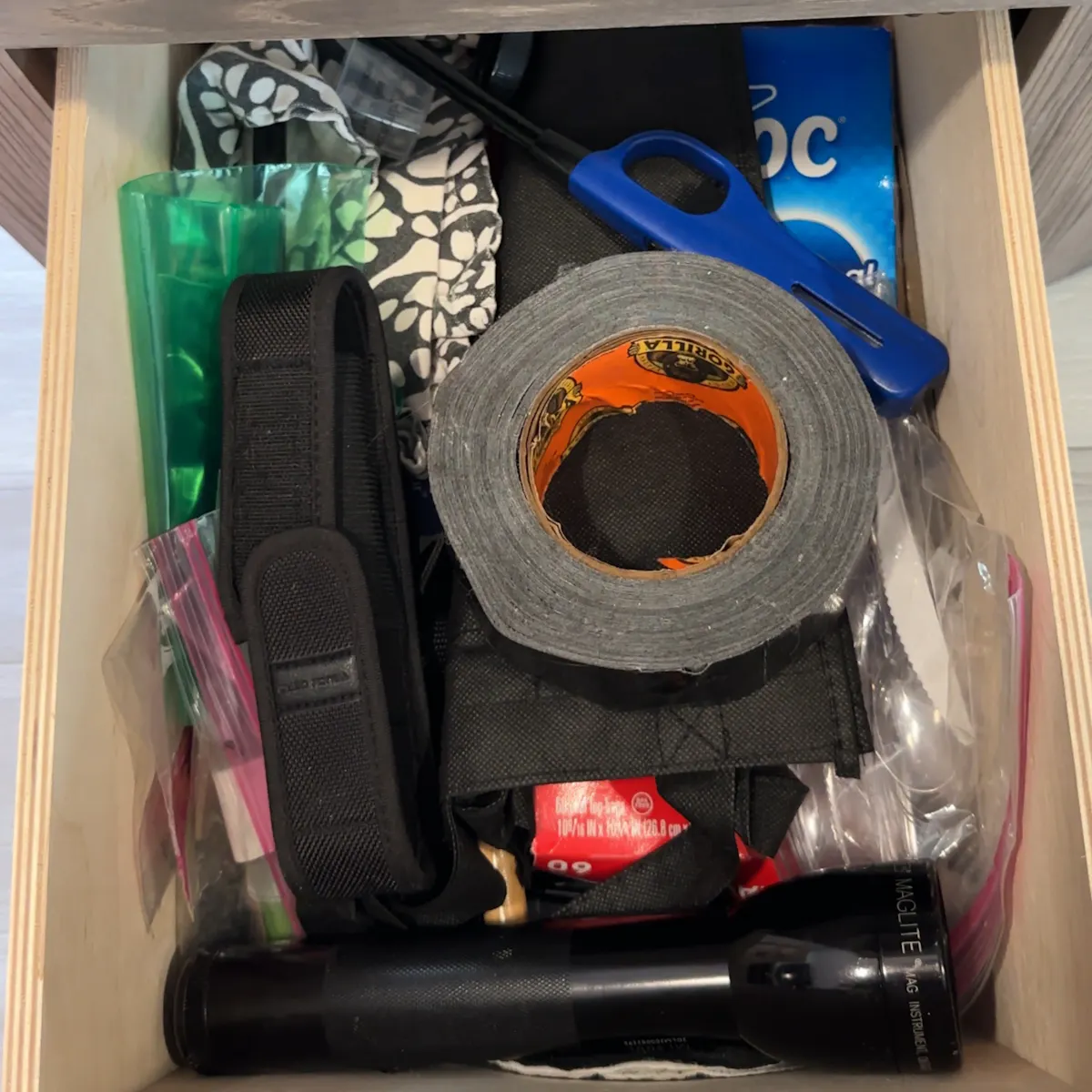 A drawer of safety and essential items inside John King's Cruiser MPG travel trailer.