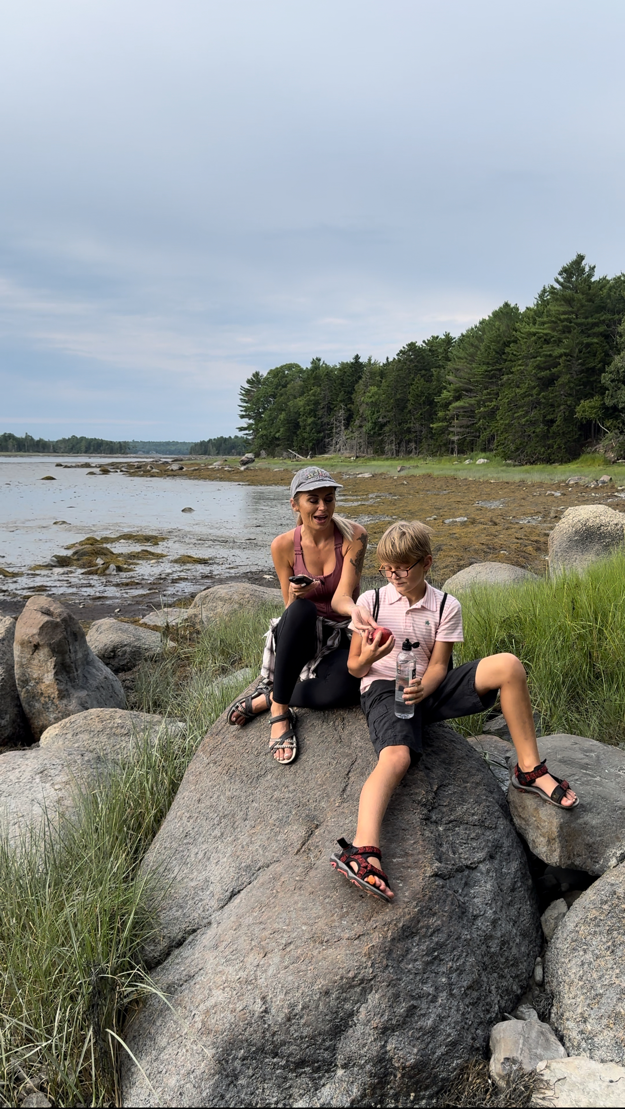 Cassie Bailey sits with her son on some rocks.