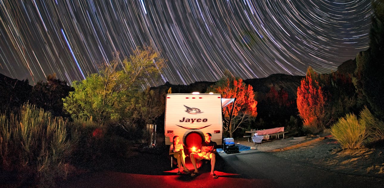 The Takacs family sit around a fire next to their Jayco Jay Flight in Kodachrome Basin State Park.
