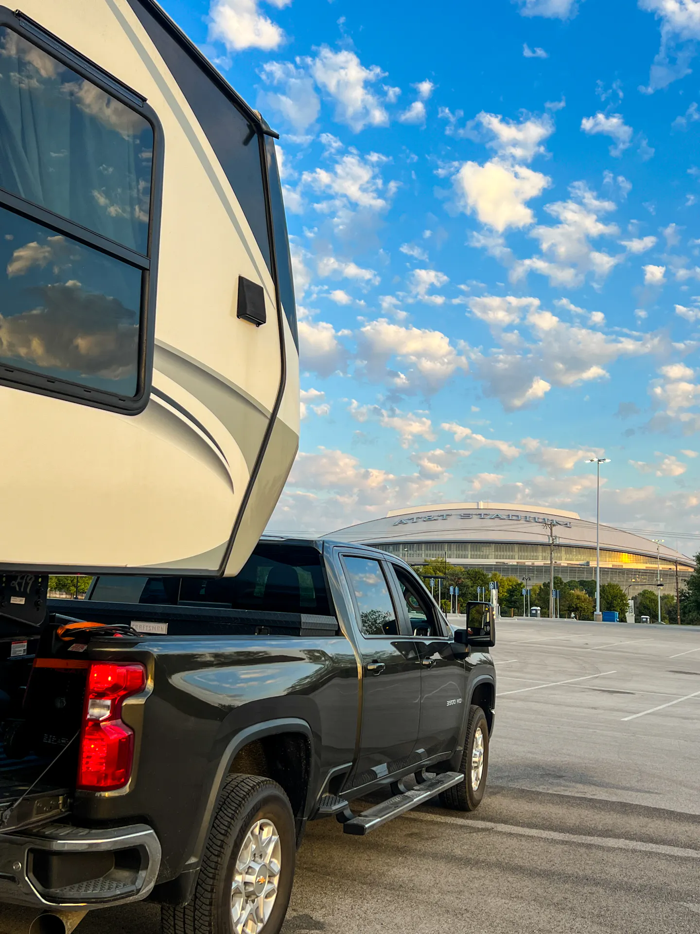 Donny and Tammy Benedict's Keystone Cougar fifth wheel hitched to their truck at a stadium.
