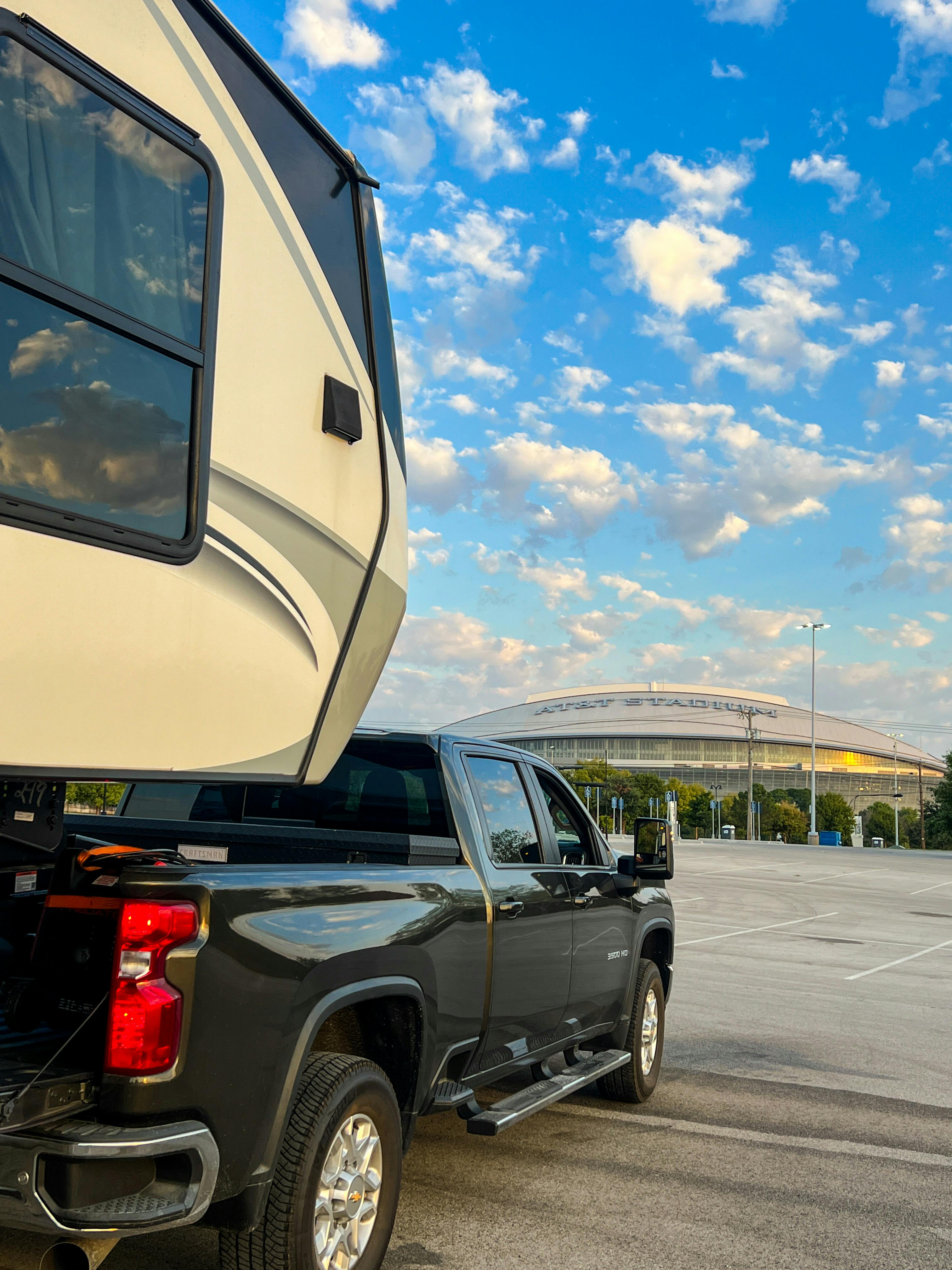 Donny and Tammy Benedict's Keystone Cougar fifth wheel hitched to their truck at a stadium.