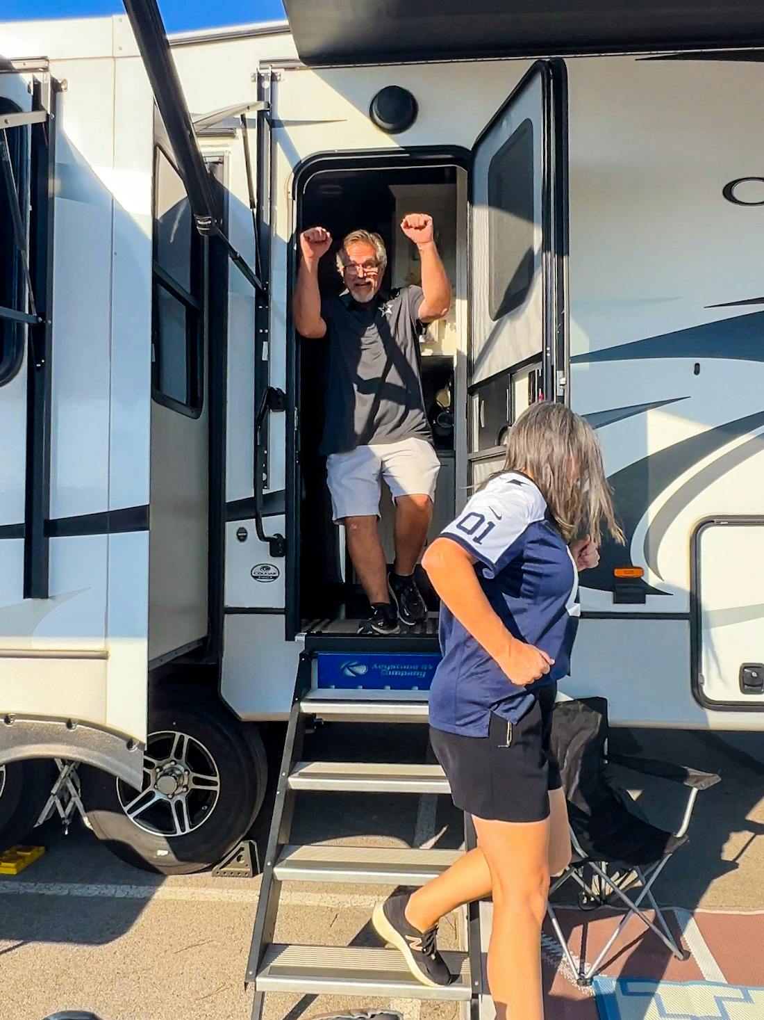 Donny and Tammy Benedict stepping out of their Keystone Cougar fifth wheel.