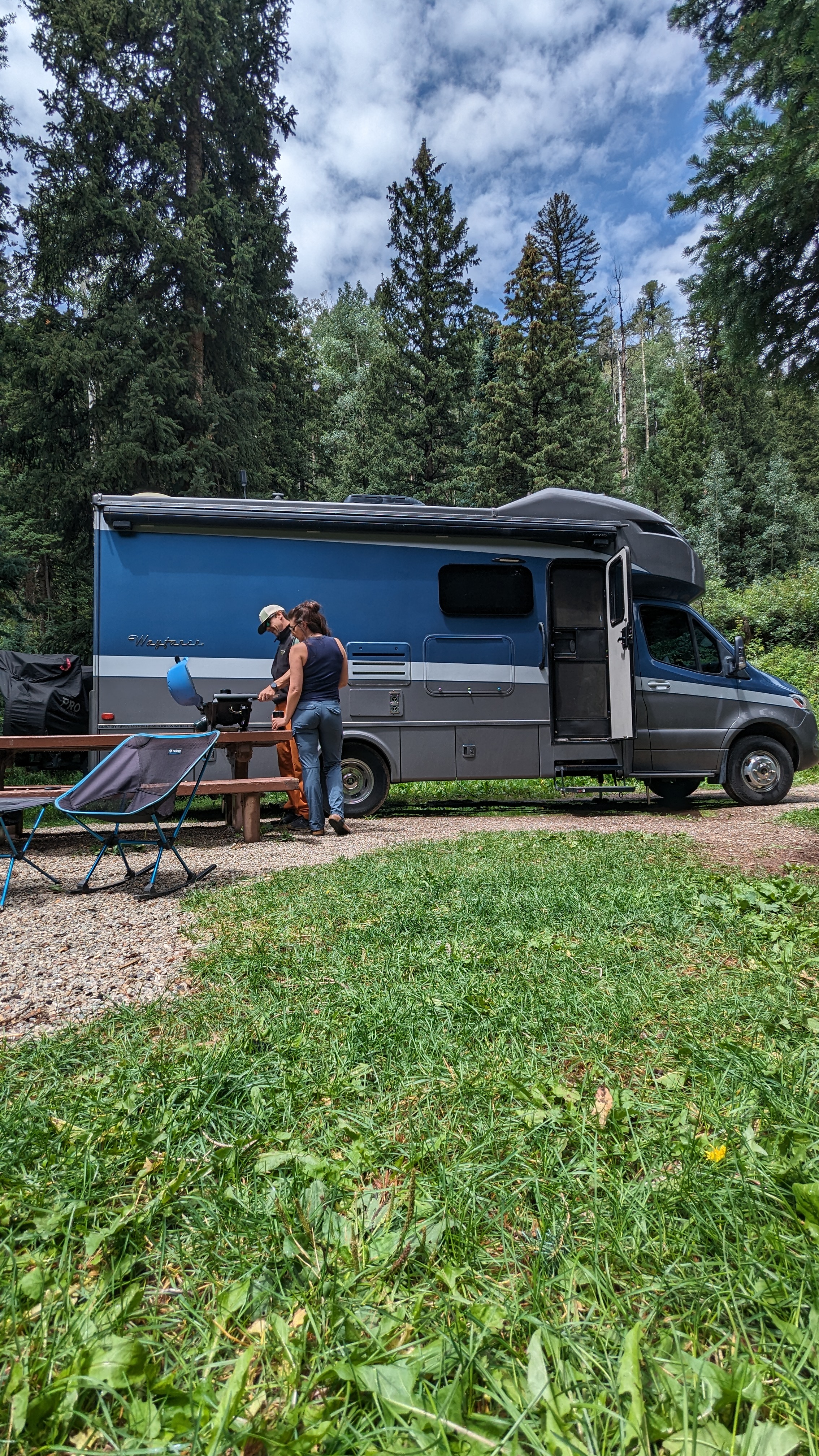 Sarah and Dustin Bauer grill at their campsite with their Tiffin Wayfarer.