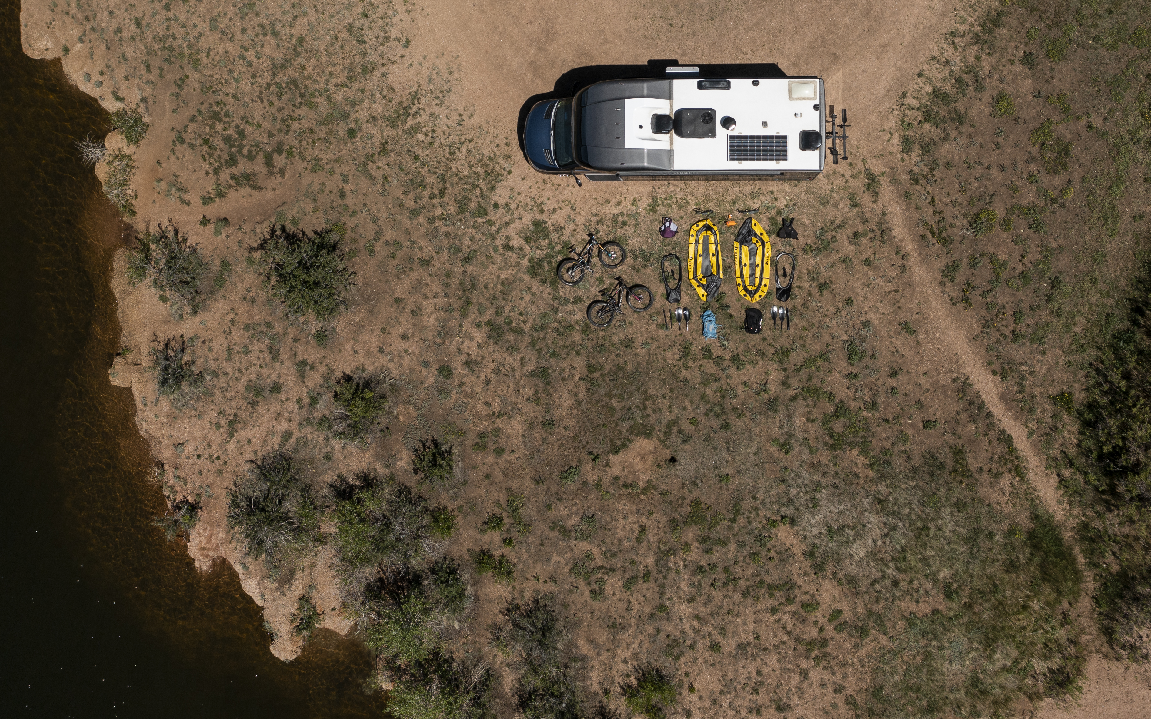 An ariel view of Dustin and Sarah's RV with all of their biking and rafting gear laid out