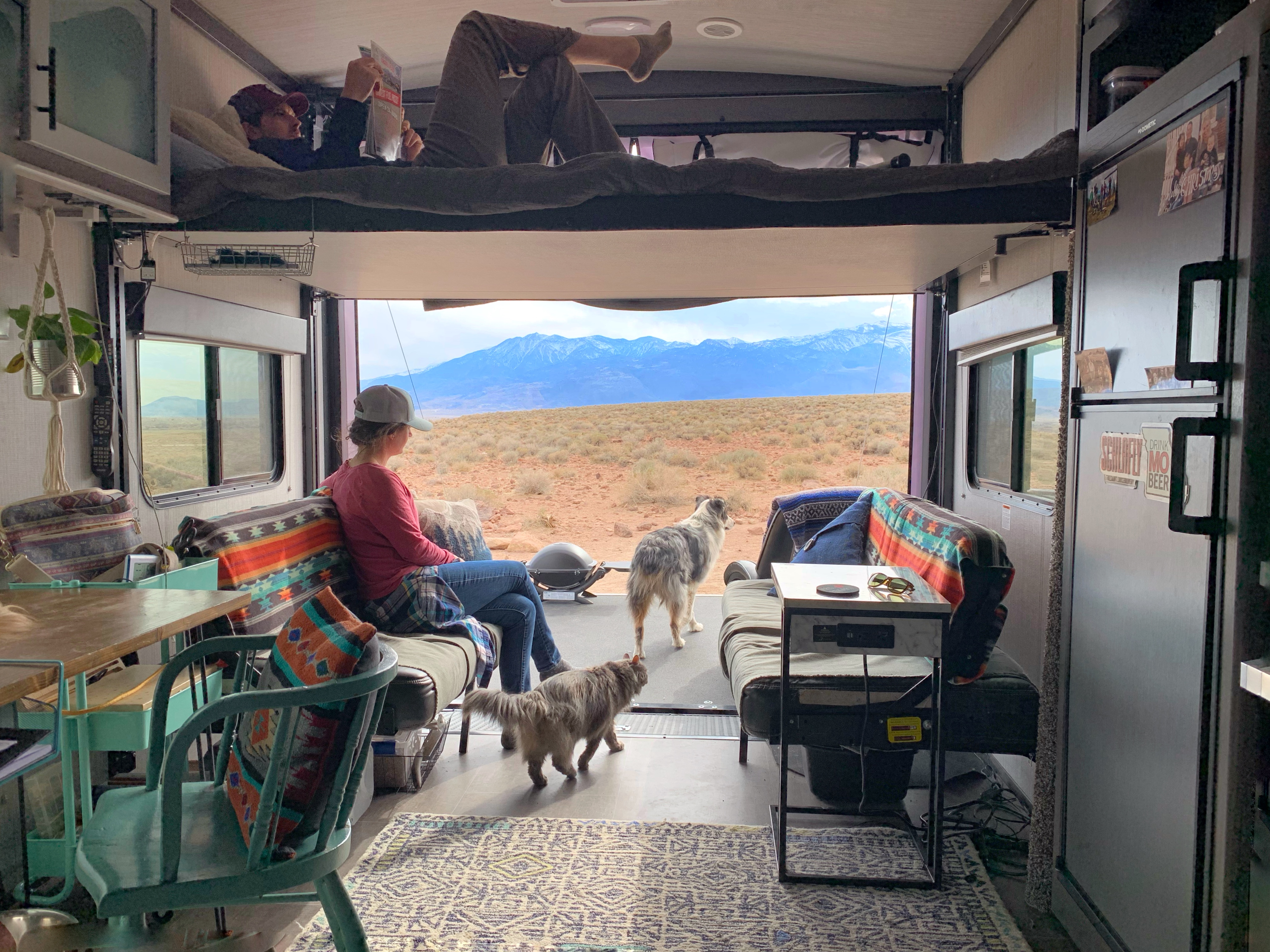 Amy Rekart looks out the back of her Cruiser Stryker toy hauler while her husband reads on the above bunk. 
