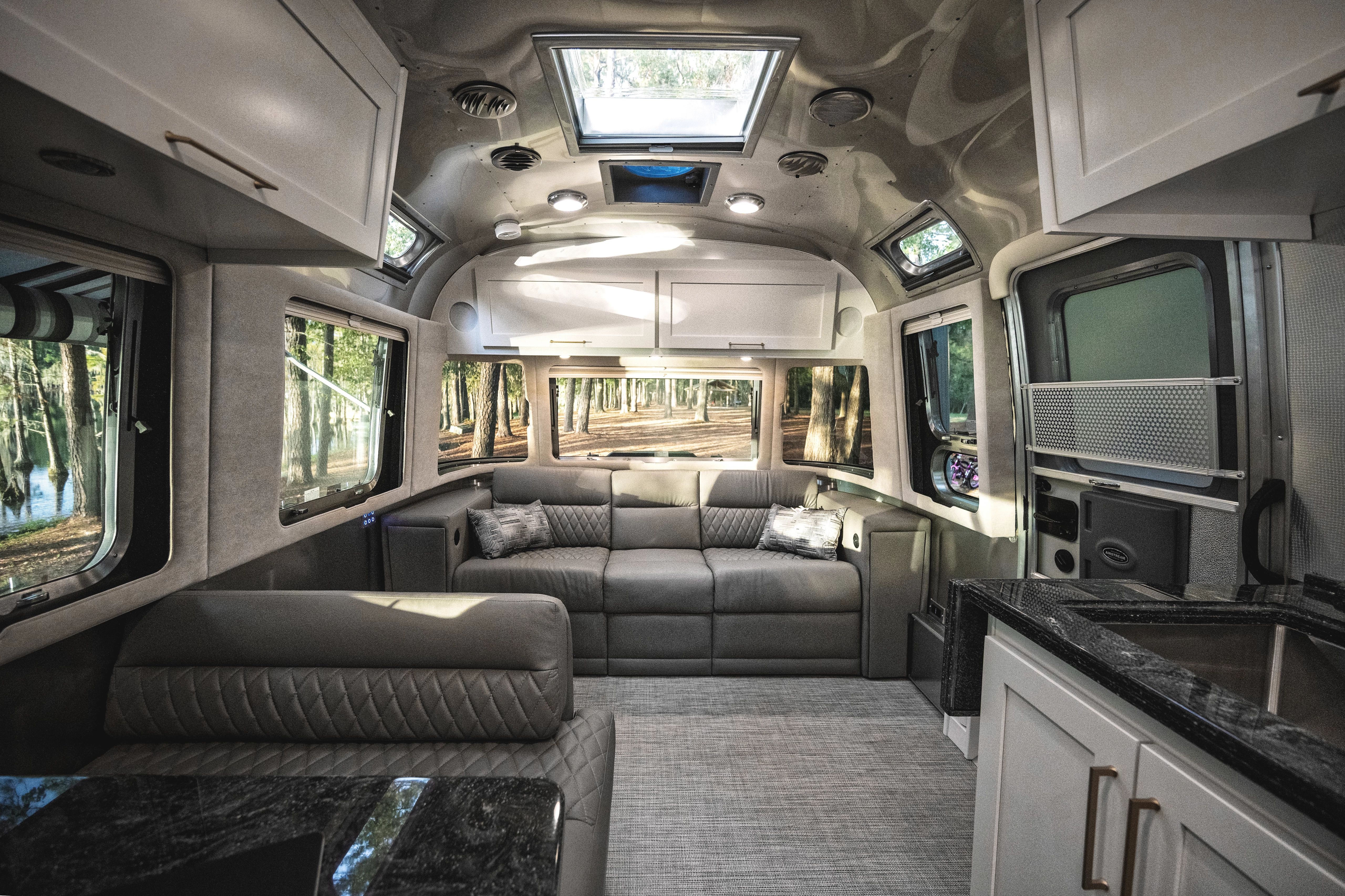 The interior kitchen and living area of an Airstream Classic