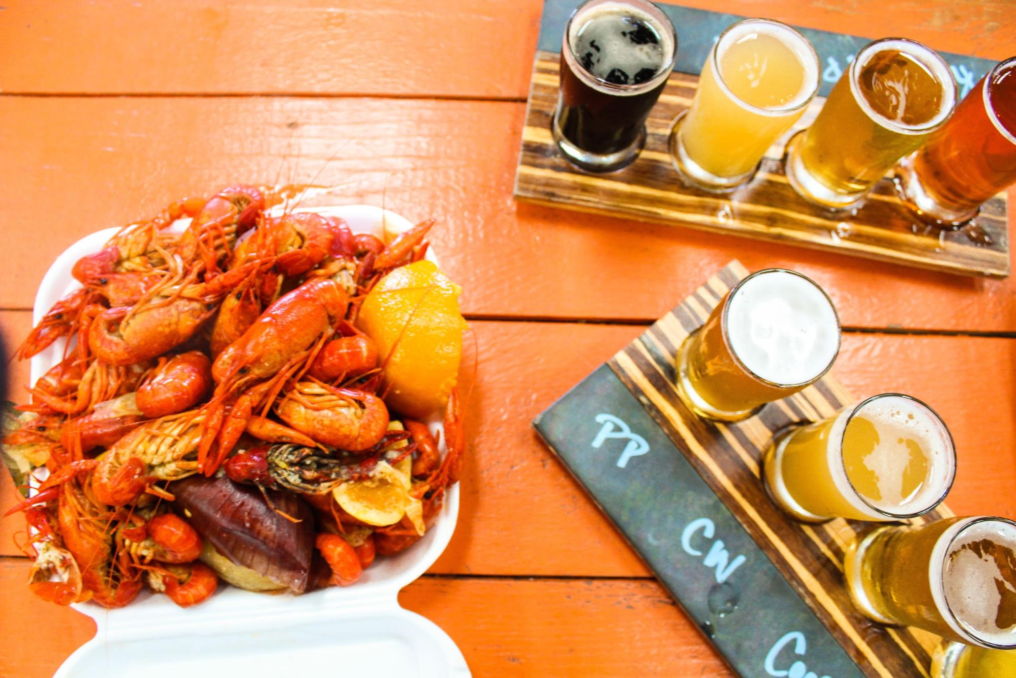 Jesse & Rachael Lyons at a restaurant with beer flights and a seafood feast.