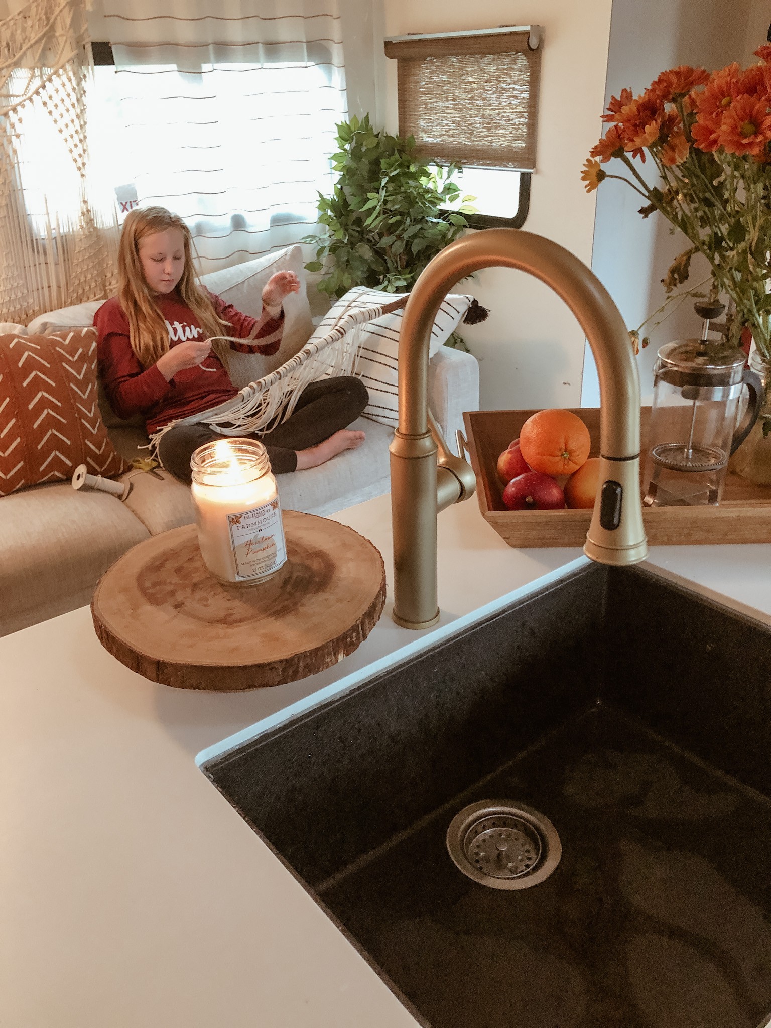 Shannon Carew's oldest child does a craft while sitting inside their Highland Ridge RV.