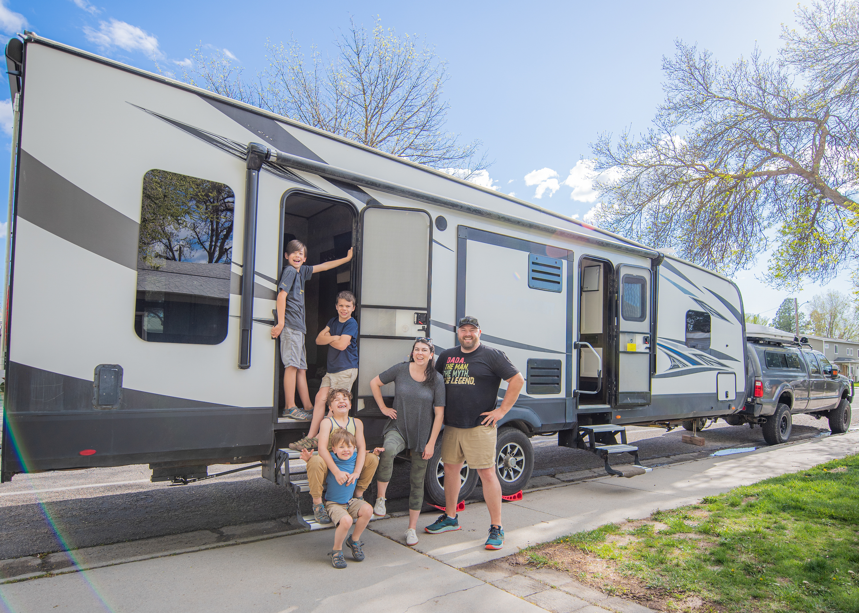 The Day family (Nate, Chelsea, and their four kids) in front of their Highland Ridge Highlander toy hauler.