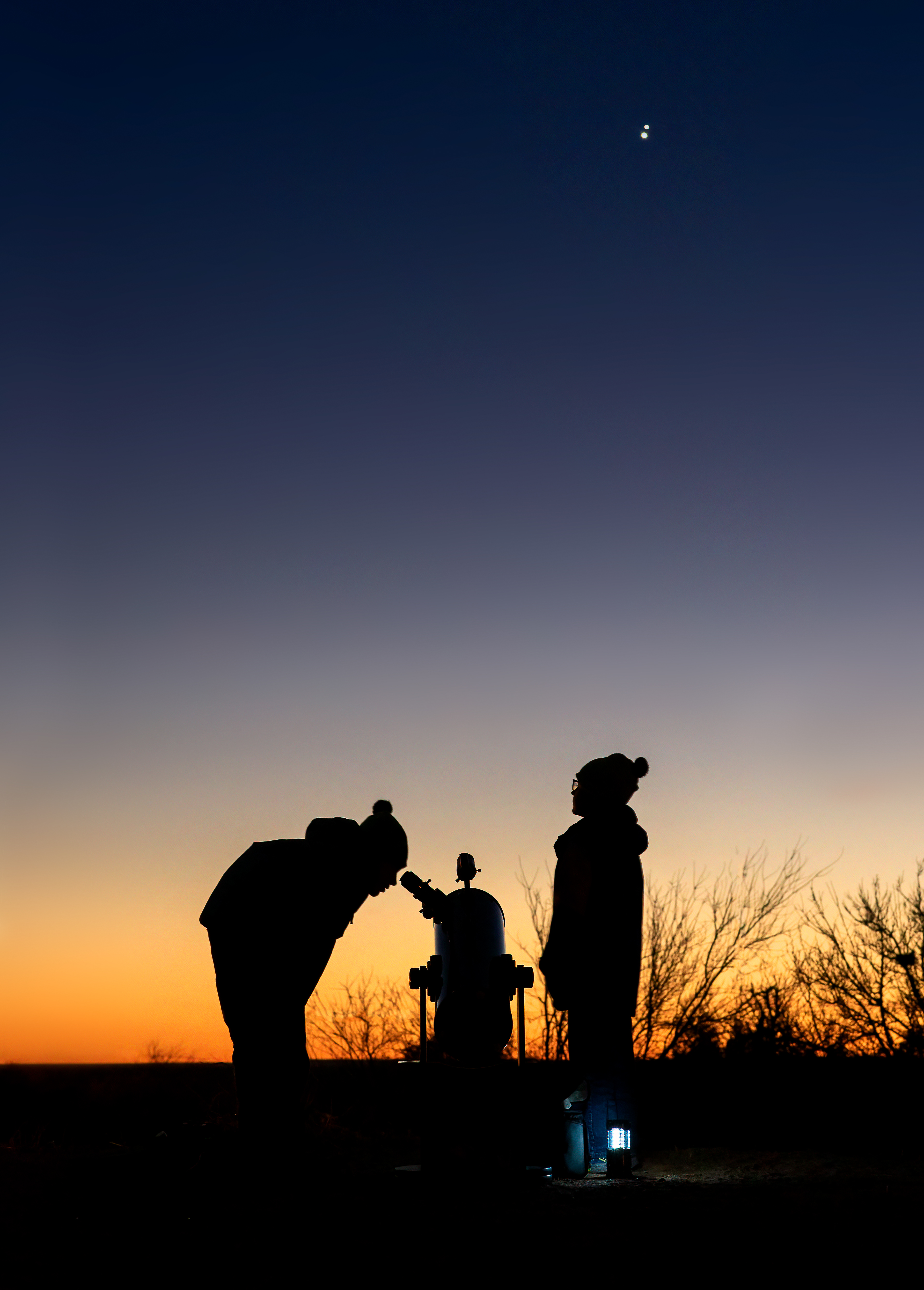 Alison Takacs's children look through a telescope.