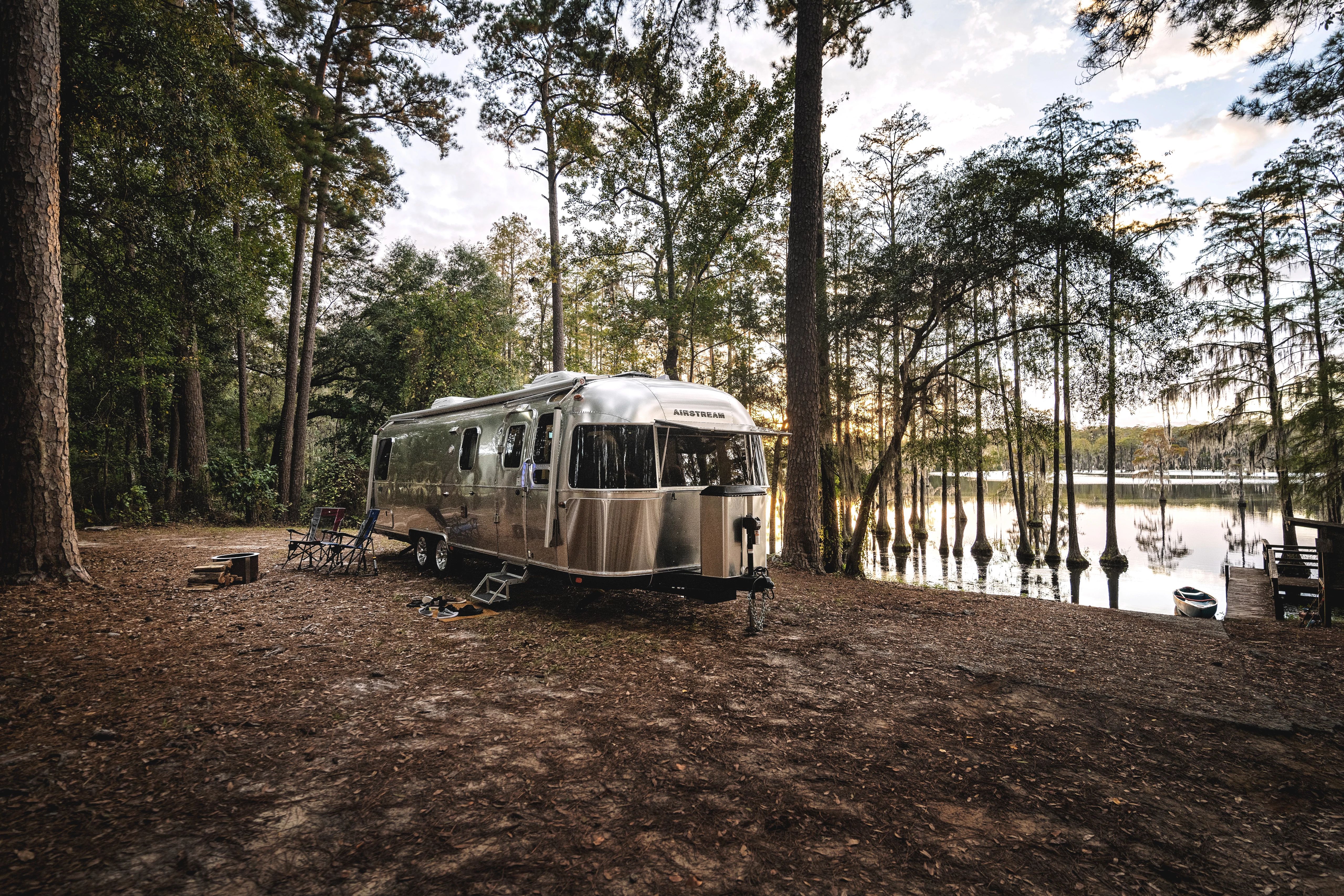 An Airstream classic boondocking by a marshy lake 