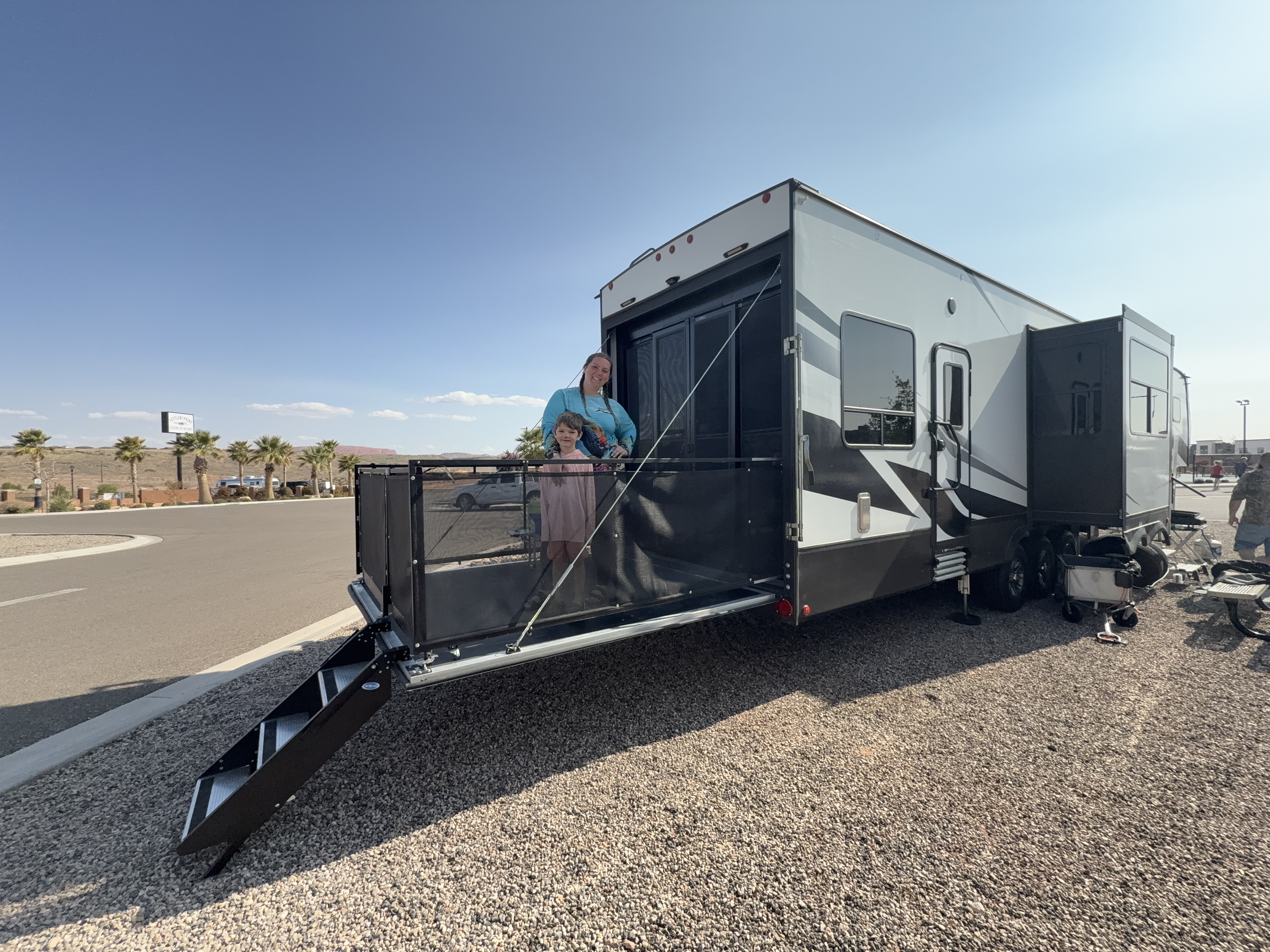 Jessica White and her son standing on the back patio of their Dutchmen Voltage Triton