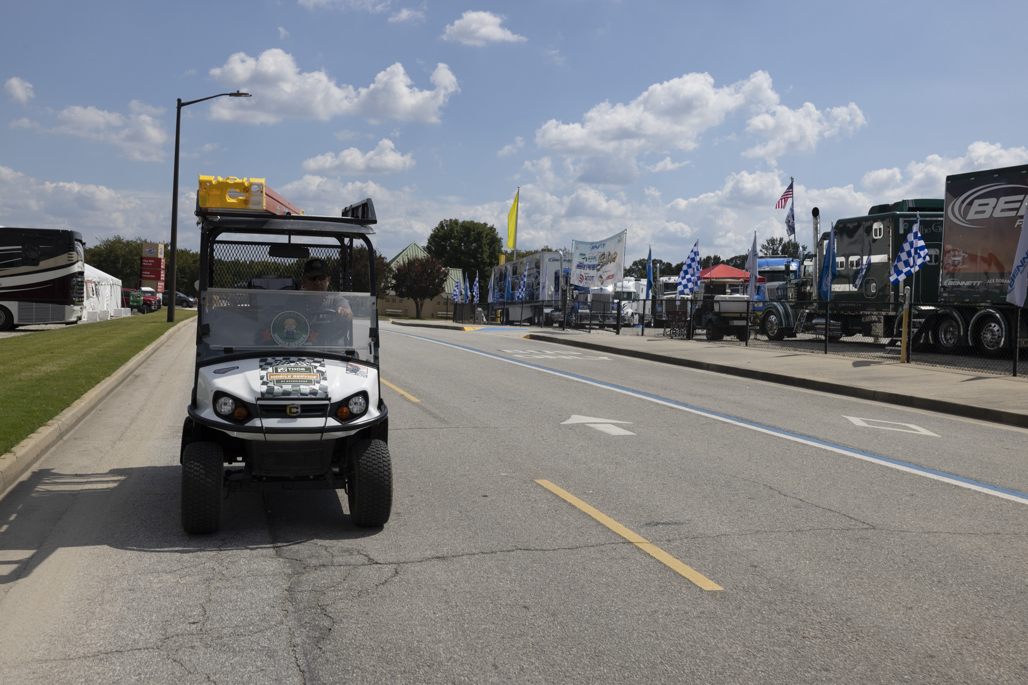 THOR's mobile RV repair service golf cart driving down the road at the Atlanta Motor Speedway